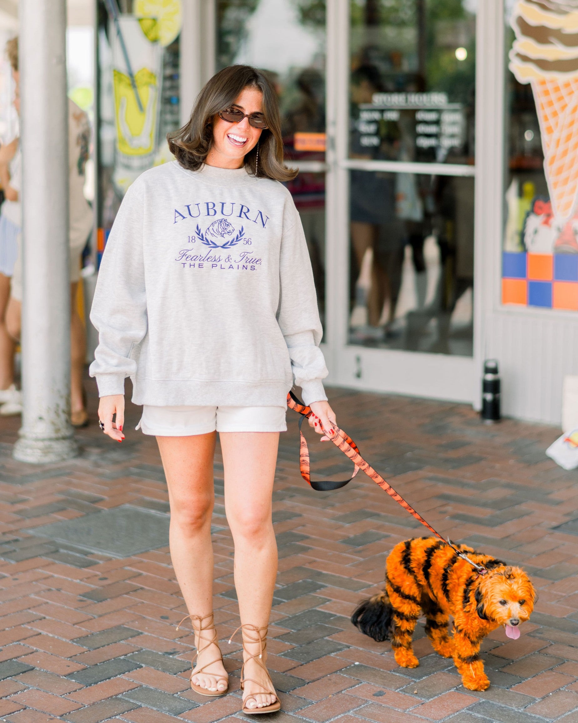 Auburn University Grey Mock Neck Sweatshirt with Navy Embroidered text “Auburn” above the tiger crest (A tiger head outline encircled by a wreath of laurels), and text “Fearless & True- The Plains”