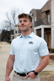 The Booth Light Blue Stripe Men’s Polo with The Booth Logo embroidered on the chest