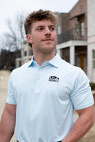 The Booth Light Blue Stripe Men’s Polo with The Booth Logo embroidered on the chest