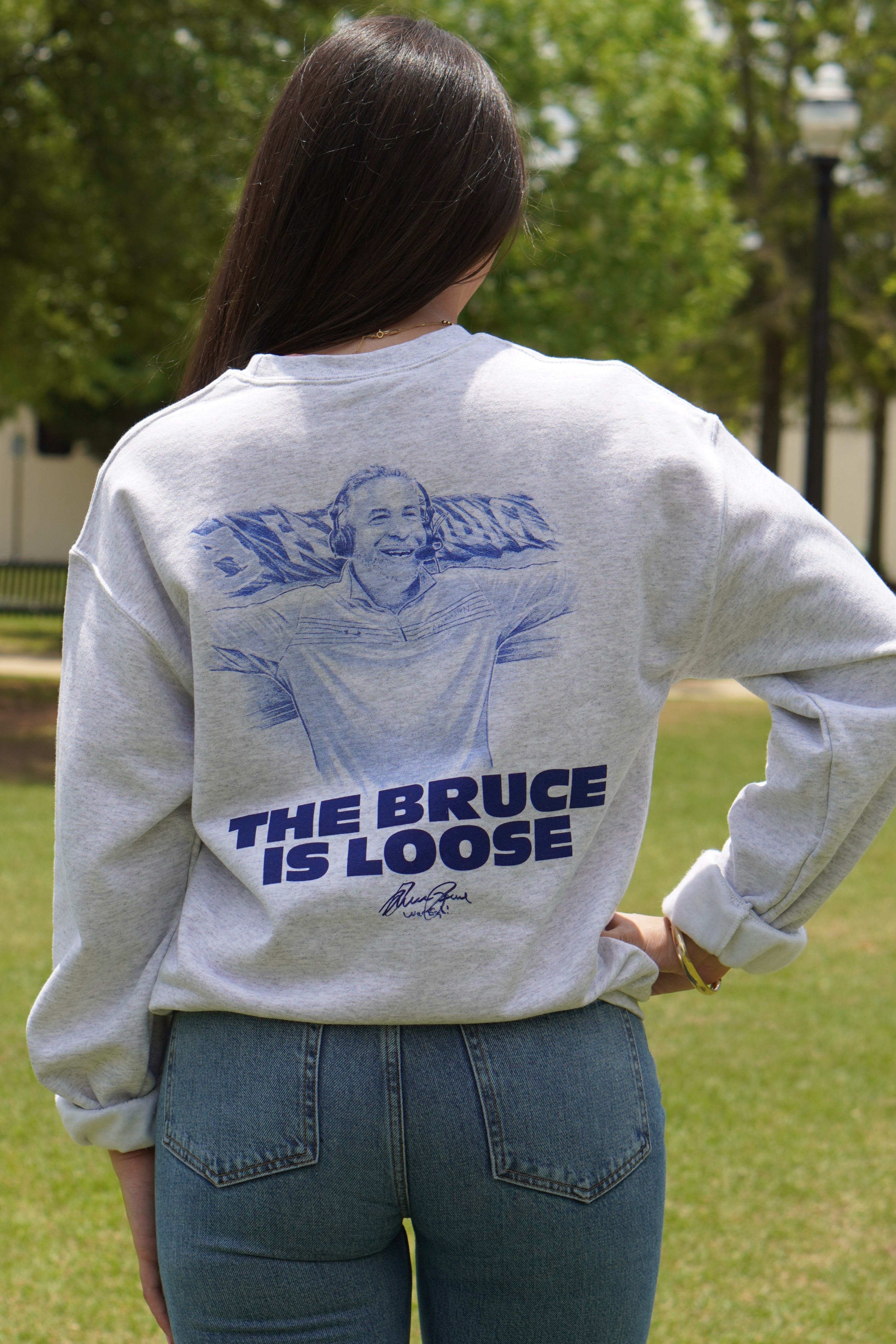 Auburn University Light Grey The Bruce is Loose Sweatshirt featuring an illustration of the Auburn Basketball coach above text "The Bruce is Loose"