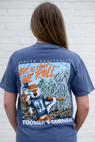 Auburn University Blue This is How We Roll T-Shirt featuring an illustration of Aubie rolling the Toomer's Corner Magnolias beneath Orange text "This Is How We Roll"