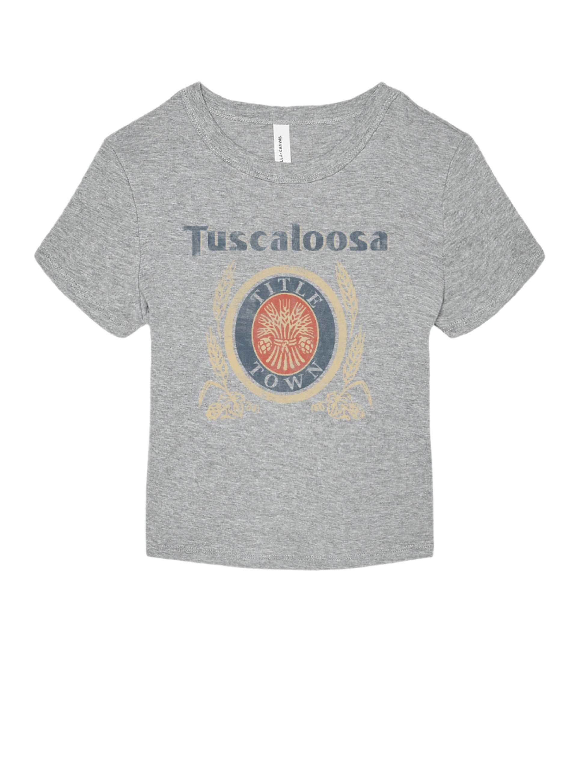 Gray Title Town Baby Tee with distressed Navy text "Tuscaloosa" above the Title Town emblem, which features Gold, Navy, and Red circles with text “Title Town” and a bundle of wheat.