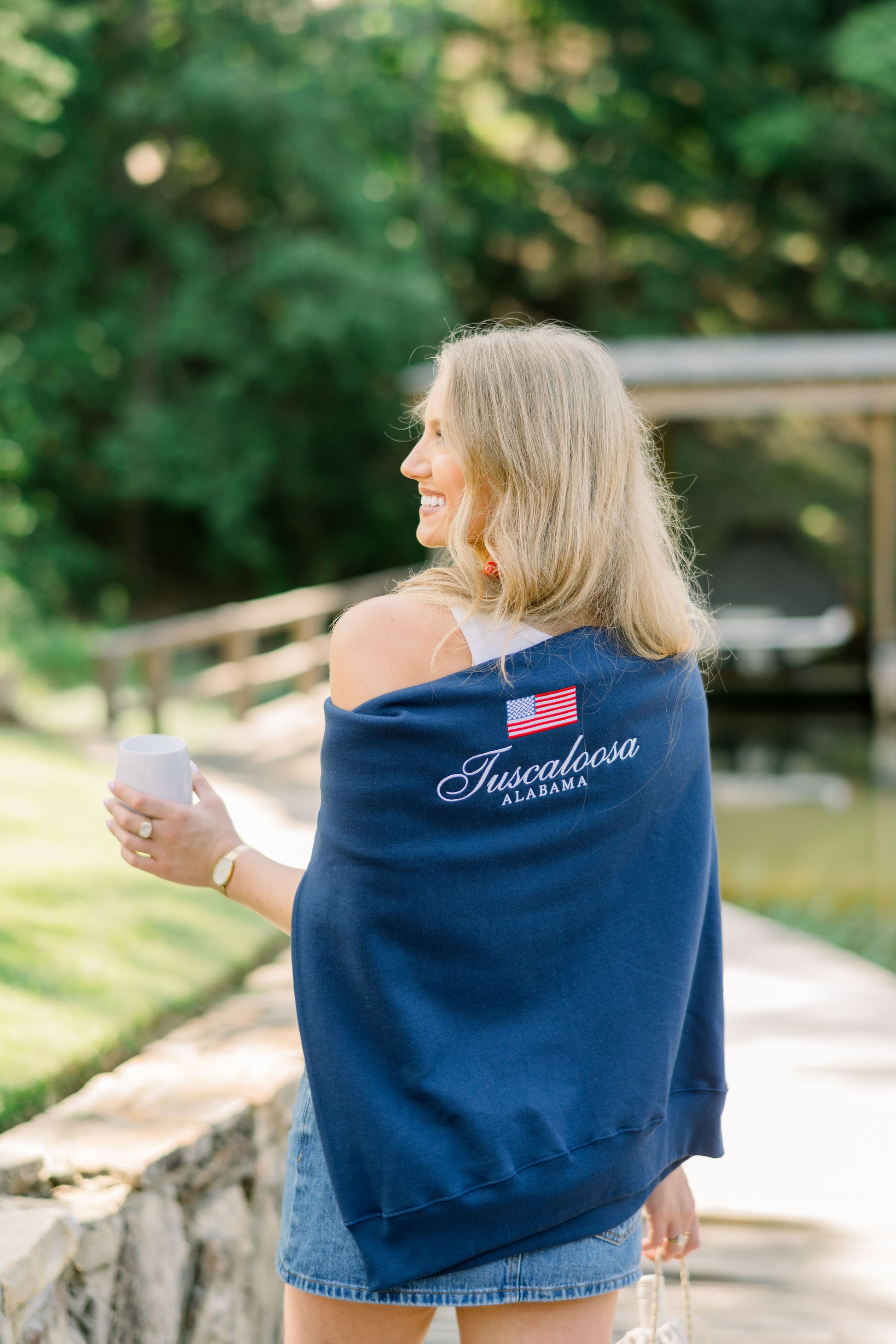 Local Merch Navy Crewneck with an embroidered American Flag above White embroidered text “Tuscaloosa Alabama”