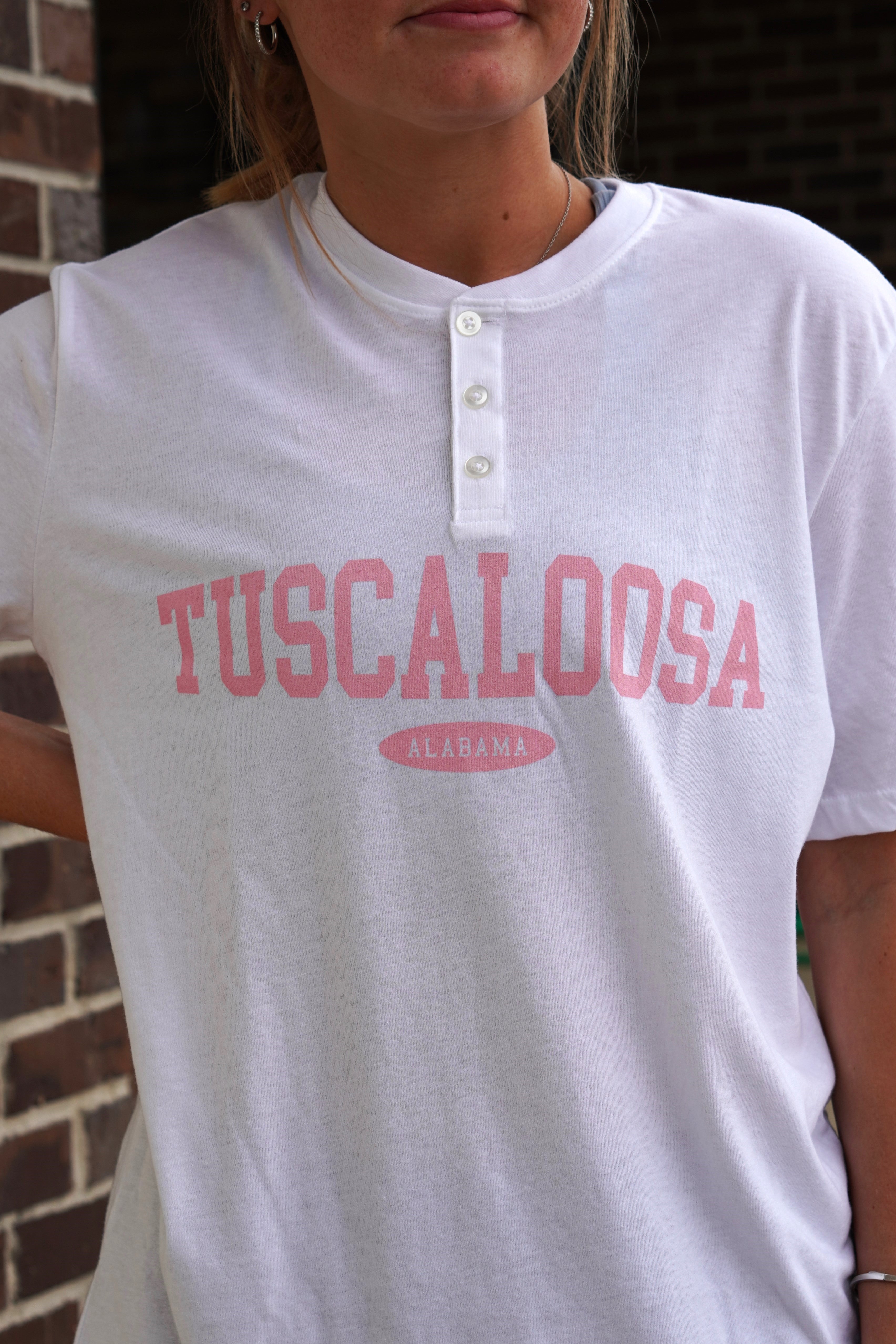 White Tuscaloosa Ladies' Henley with Pink text "Tuscaloosa"