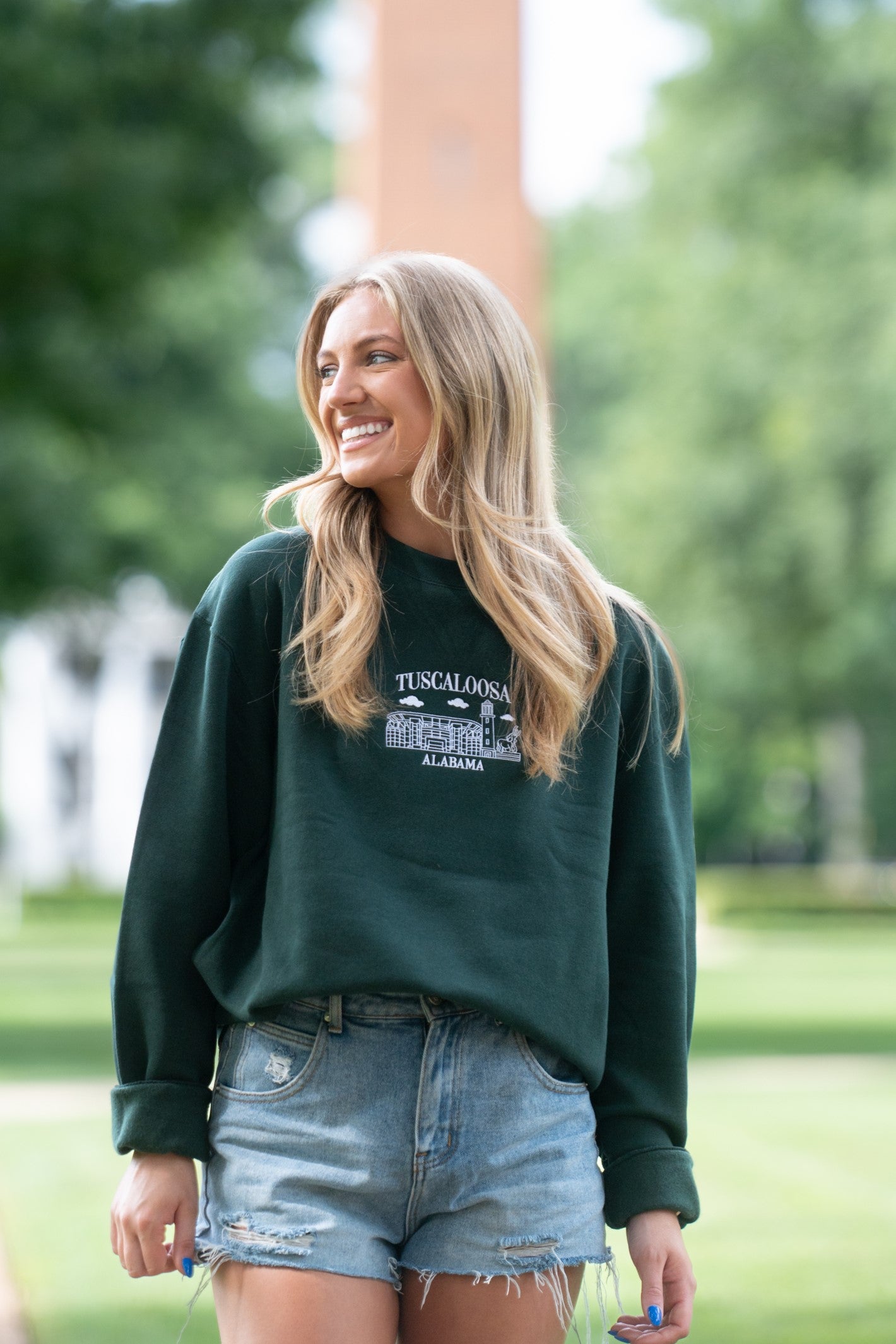 University of Alabama Tuscaloosa Landmarks Dark Green Lane Seven Ladies' Sweatshirt with White embroidery of Tuscaloosa landmarks under text "Tuscaloosa"