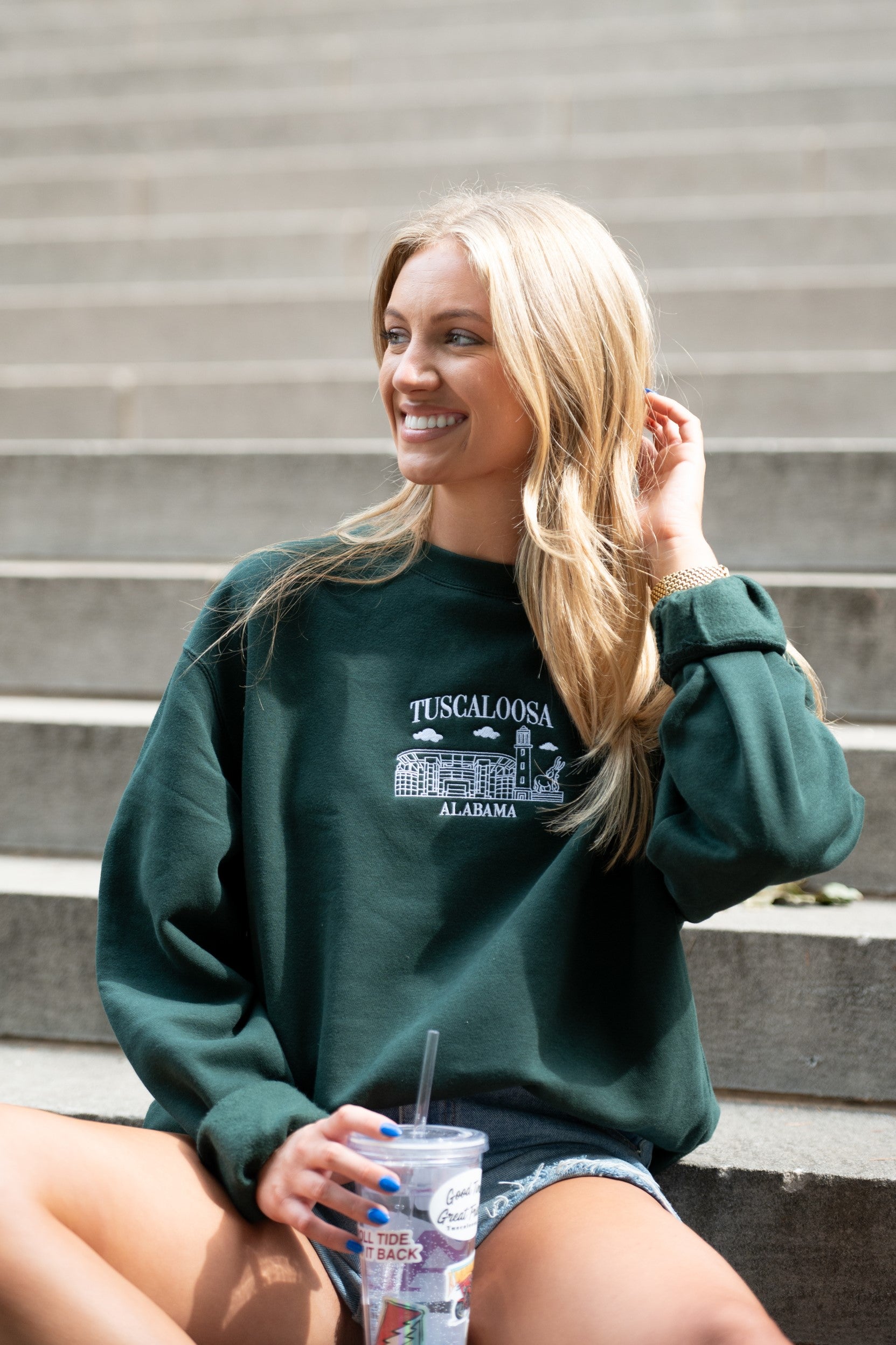 University of Alabama Tuscaloosa Landmarks Dark Green Lane Seven Ladies' Sweatshirt with White embroidery of Tuscaloosa landmarks under text "Tuscaloosa"