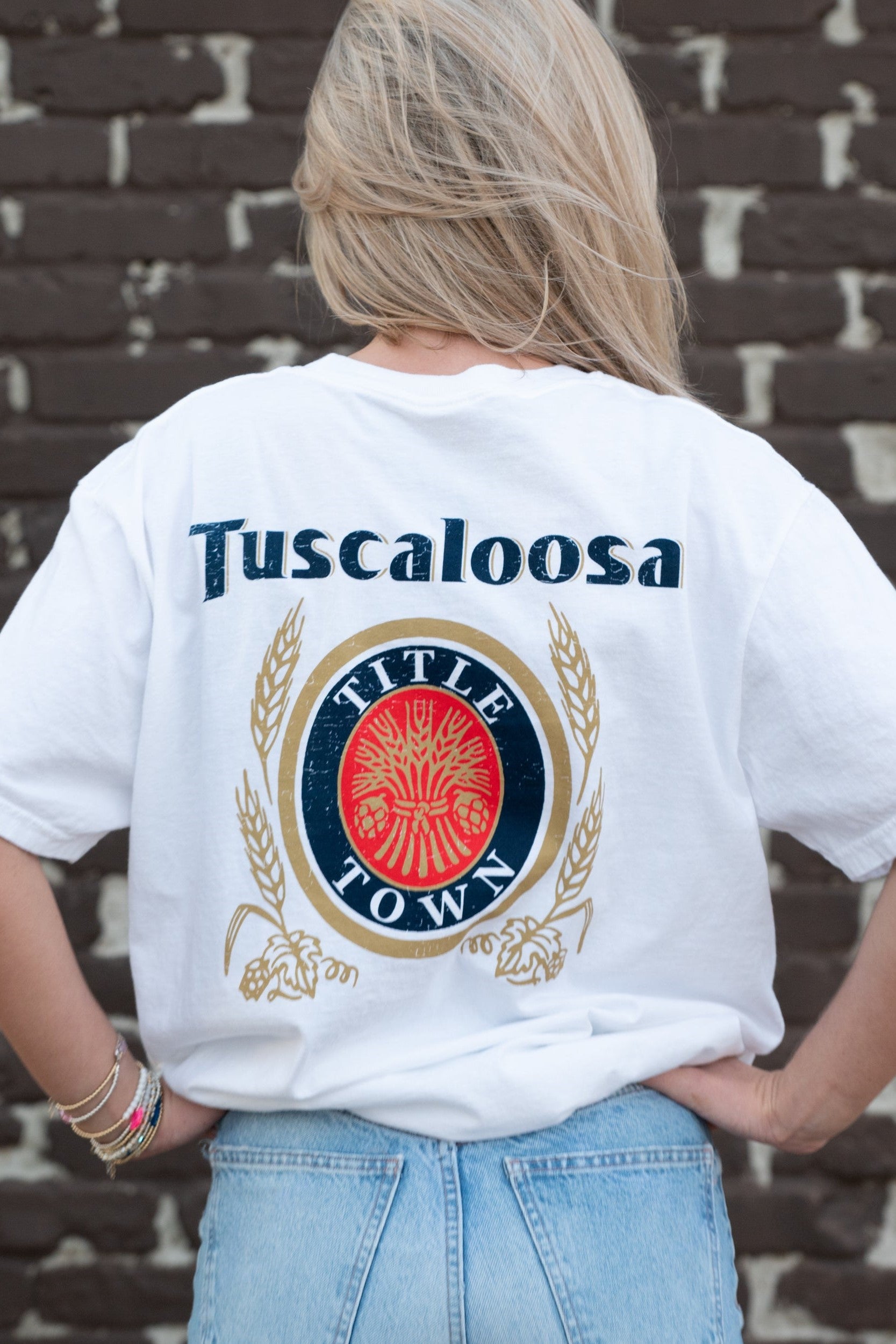 Tuscaloosa White T-Shirt with Navy text "Tuscaloosa" above the Title Town emblem