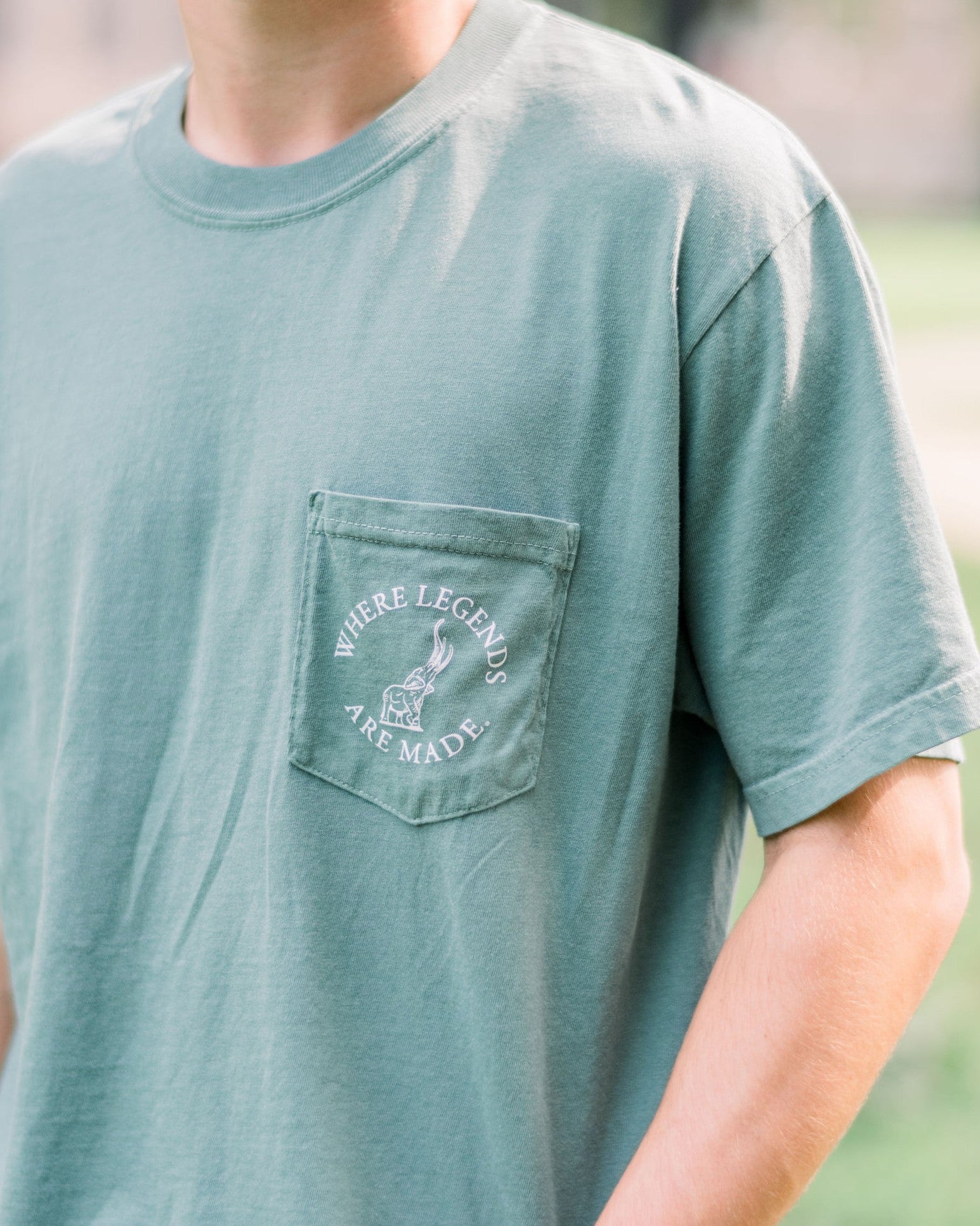 University of Alabama Green Front Pocket with White text “Where Legends Are Made” surrounding a graphic of the Tuska Statue