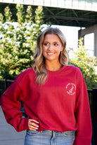 University of Alabama Red Sweatshirt with an image of the Tuska Statue underneath White text "Where Legends Are Made"