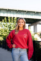 University of Alabama Red Sweatshirt with an image of the Tuska Statue underneath White text "Where Legends Are Made"