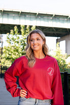 University of Alabama Red Sweatshirt with an image of the Tuska Statue underneath White text "Where Legends Are Made"