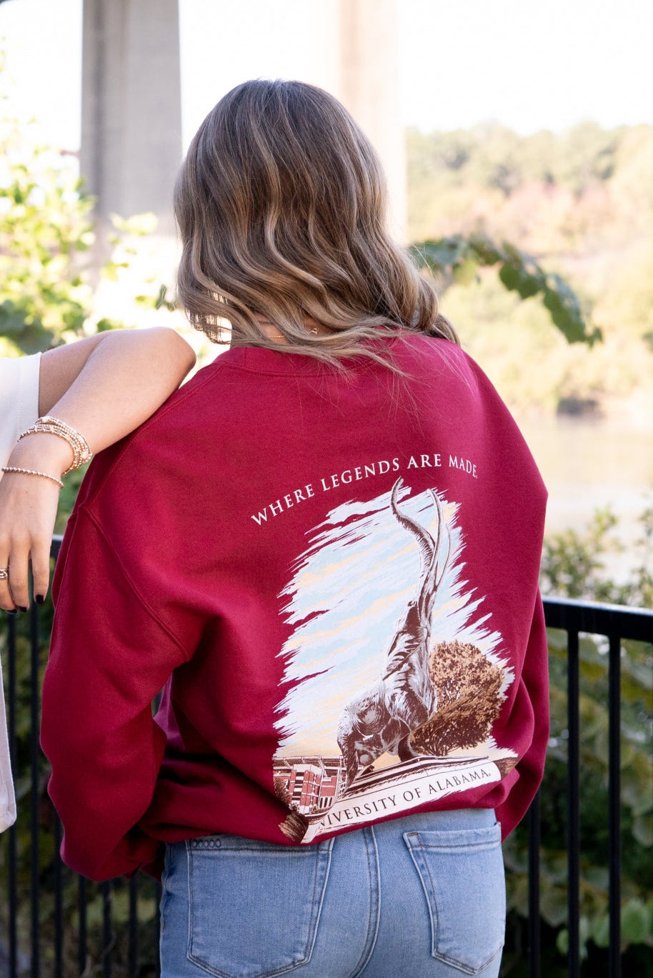 University of Alabama Red Sweatshirt with an image of the Tuska Statue underneath White text "Where Legends Are Made"