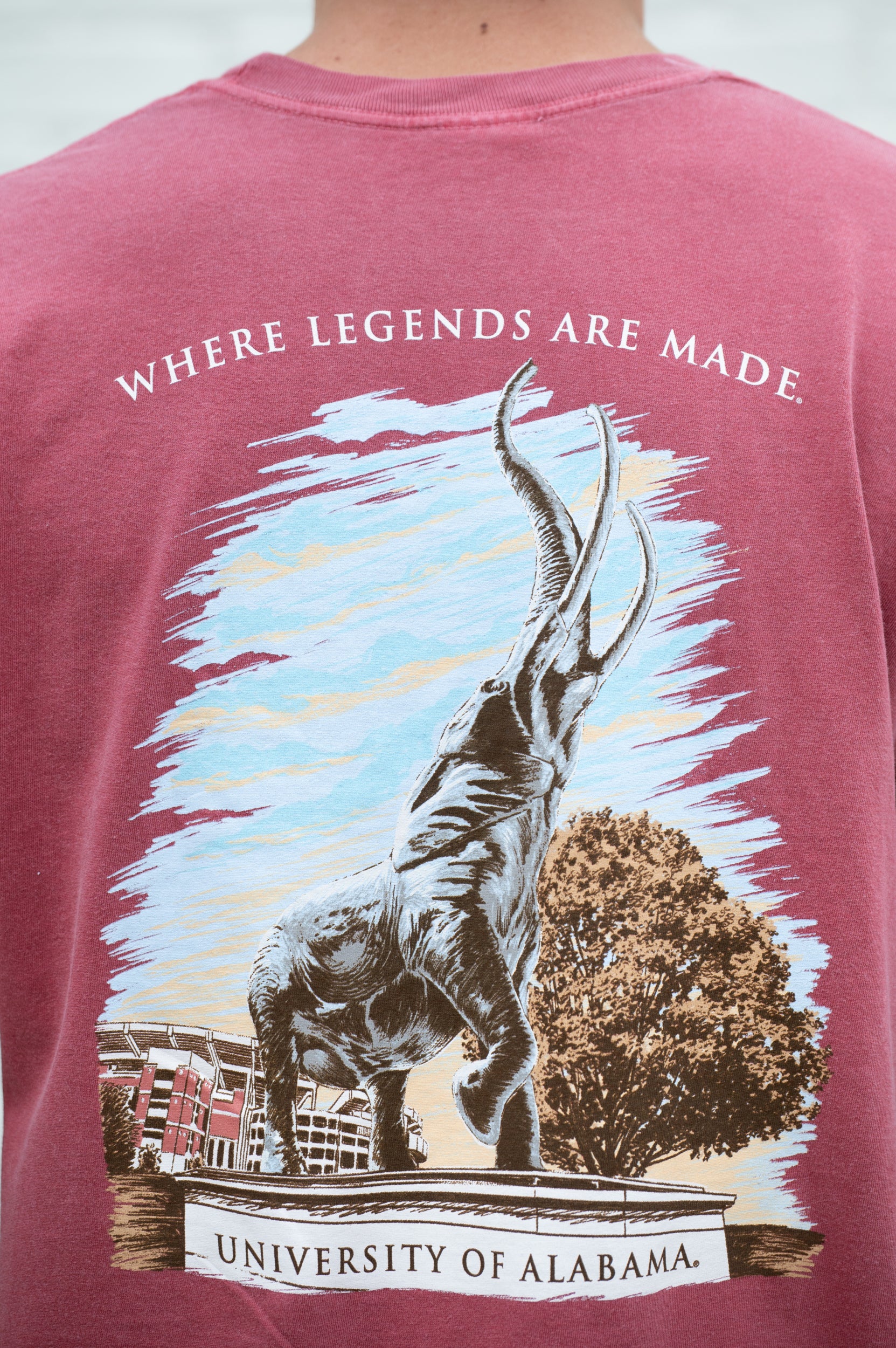 University of Alabama Red T-Shirt with an image of the Tuska Statue underneath White text "Where Legends Are Made"