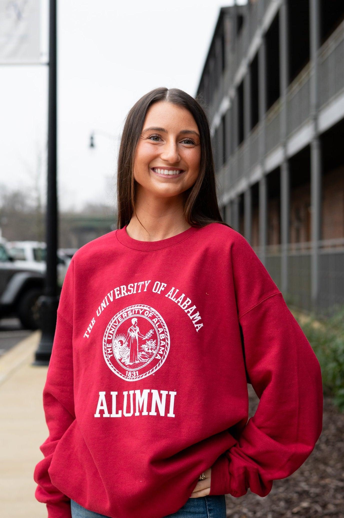 University of Alabama Red Alumni Sweatshirt with White text "University of Alabama" above the White Alumni Seal and White text "Alumni" below