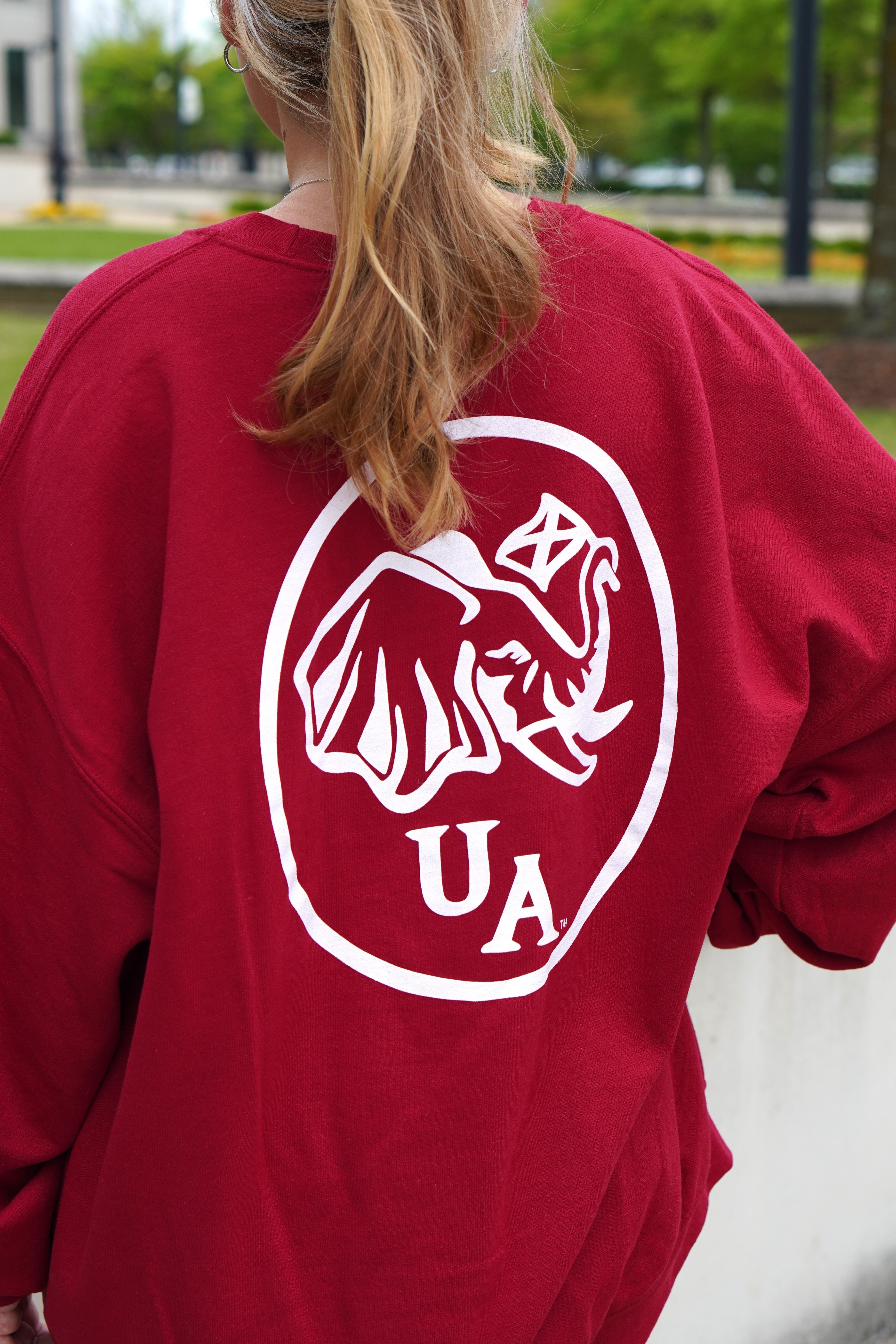 University of Alabama Red Elephant Seal Sweatshirt with an image of an elephant holding an Alabama State flag above he letters "UA"
