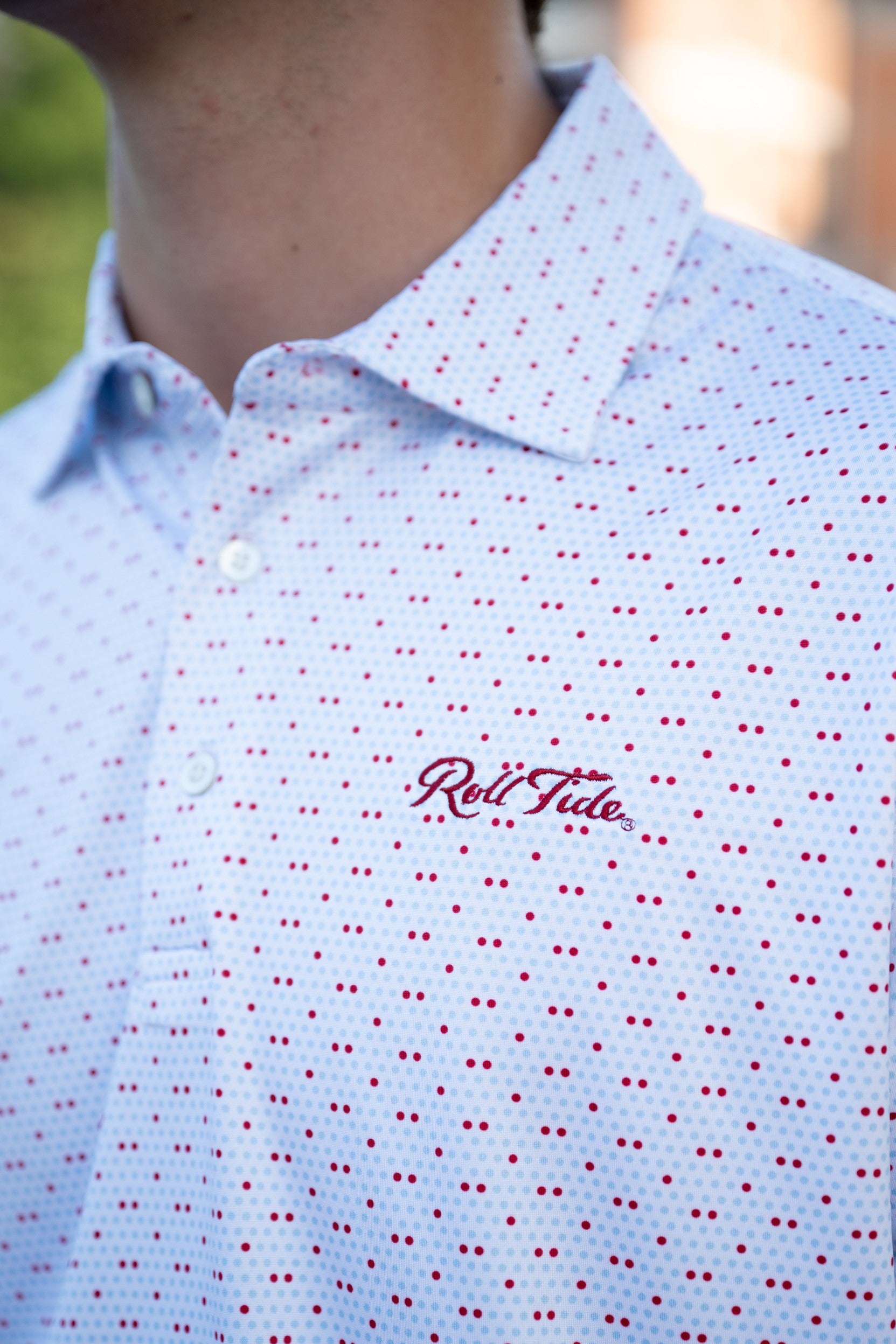 University of Alabama White Men's Dot Polo with a pattern of Light Blue and Red dots and Red script "Roll Tide" embroidery