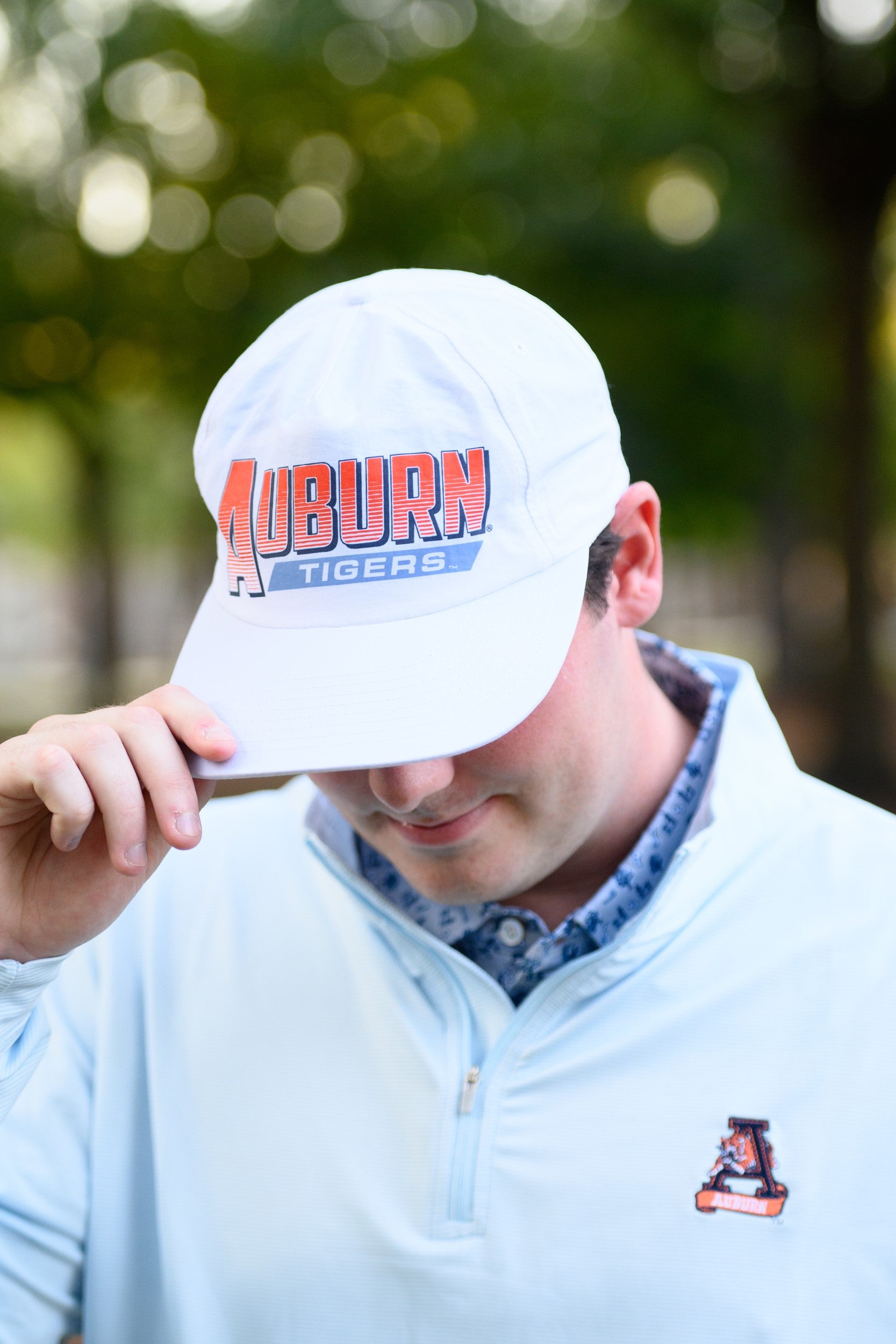 Auburn University White Hat with Orange text "Auburn" above a Blue Stripe with White text "Tigers"