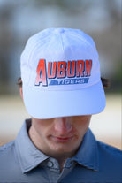 Auburn University White Hat with Orange text "Auburn" above a Blue Stripe with White text "Tigers"
