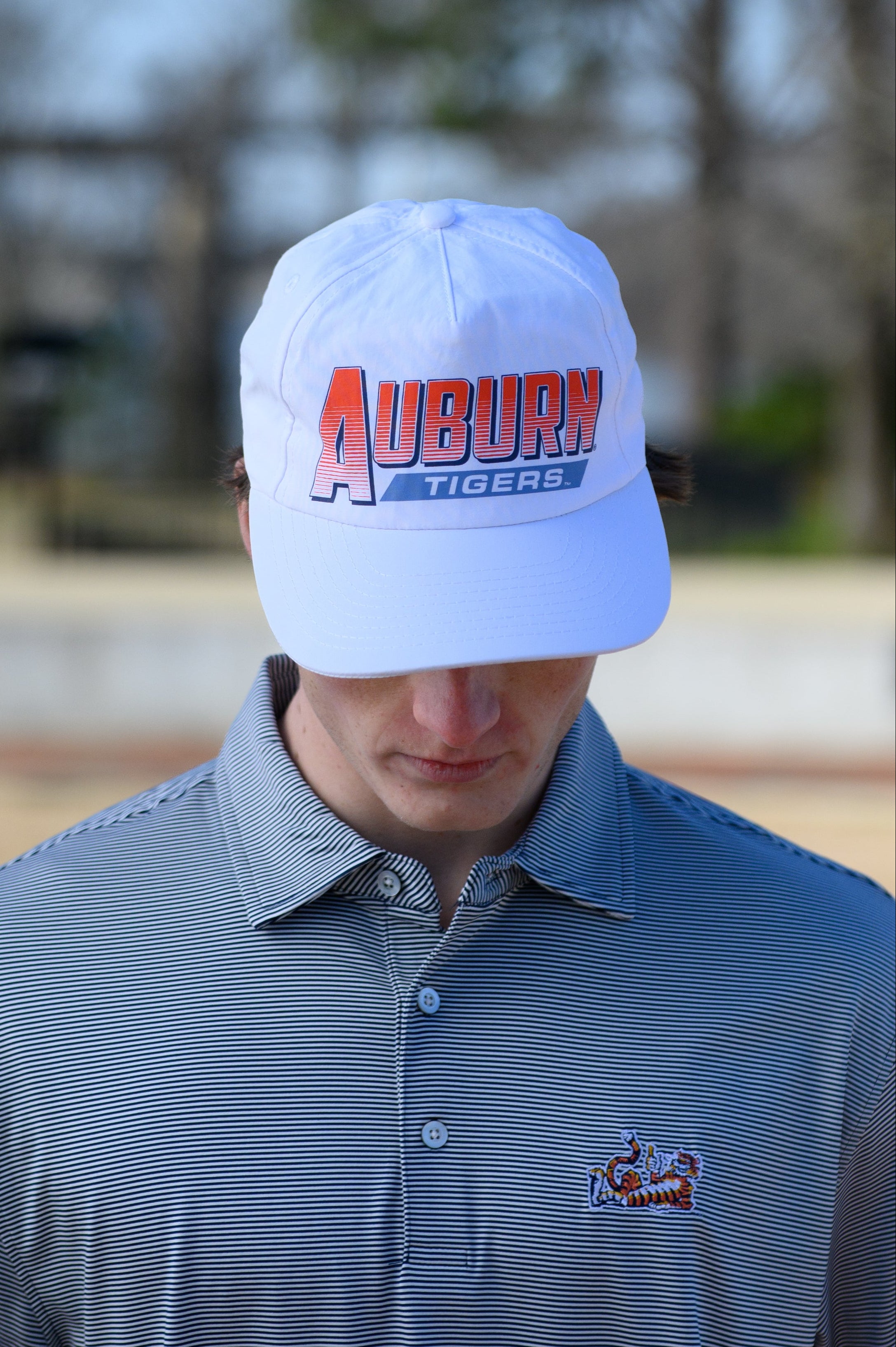 Auburn University White Hat with Orange text "Auburn" above a Blue Stripe with White text "Tigers"