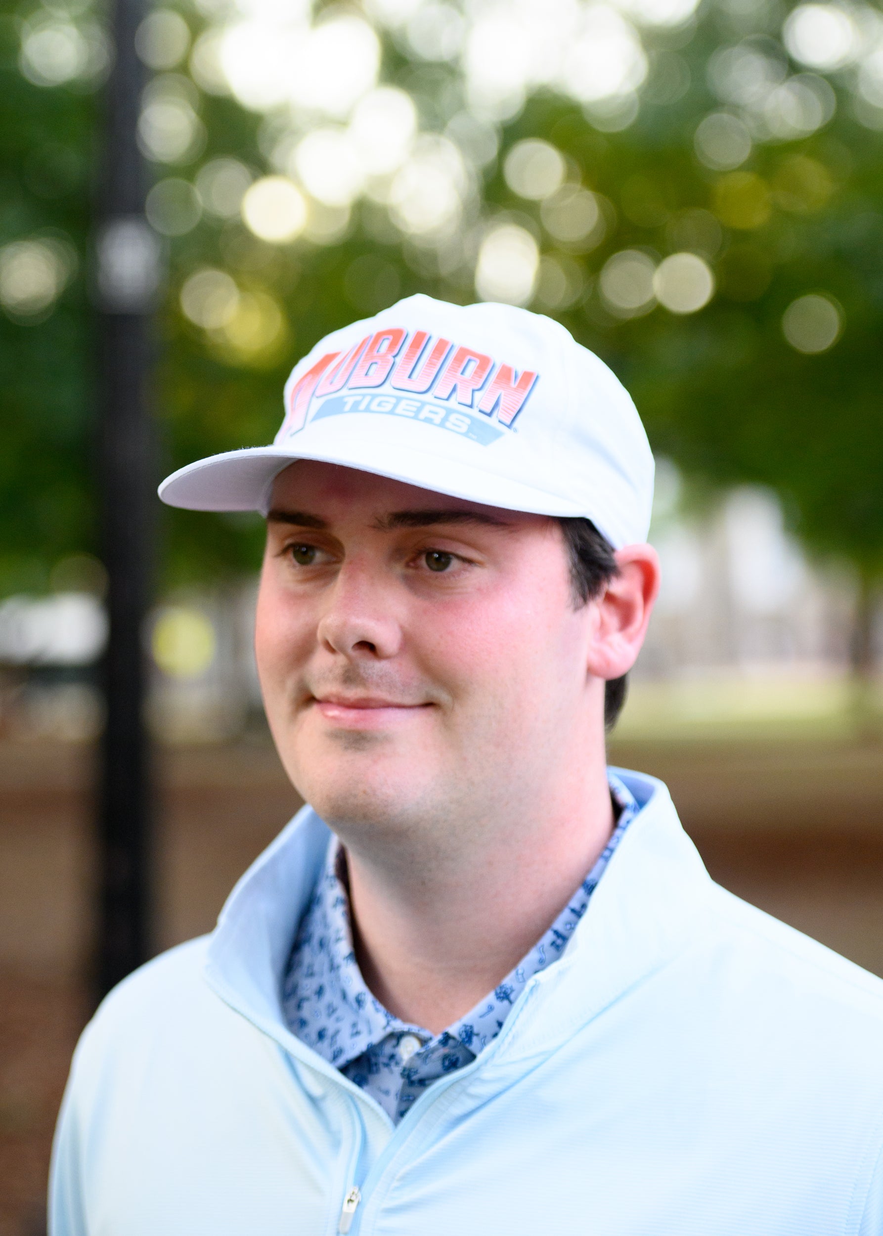 Auburn University White Hat with Orange text "Auburn" above a Blue Stripe with White text "Tigers"