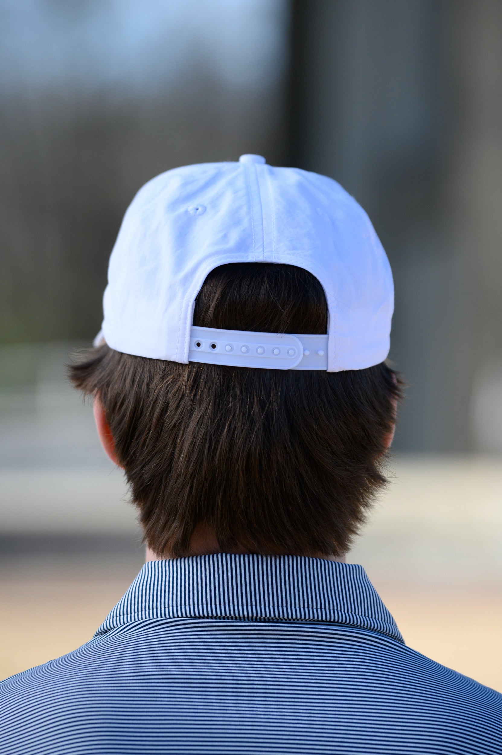 Auburn University White Hat with Orange text "Auburn" above a Blue Stripe with White text "Tigers."
Snapback Hat