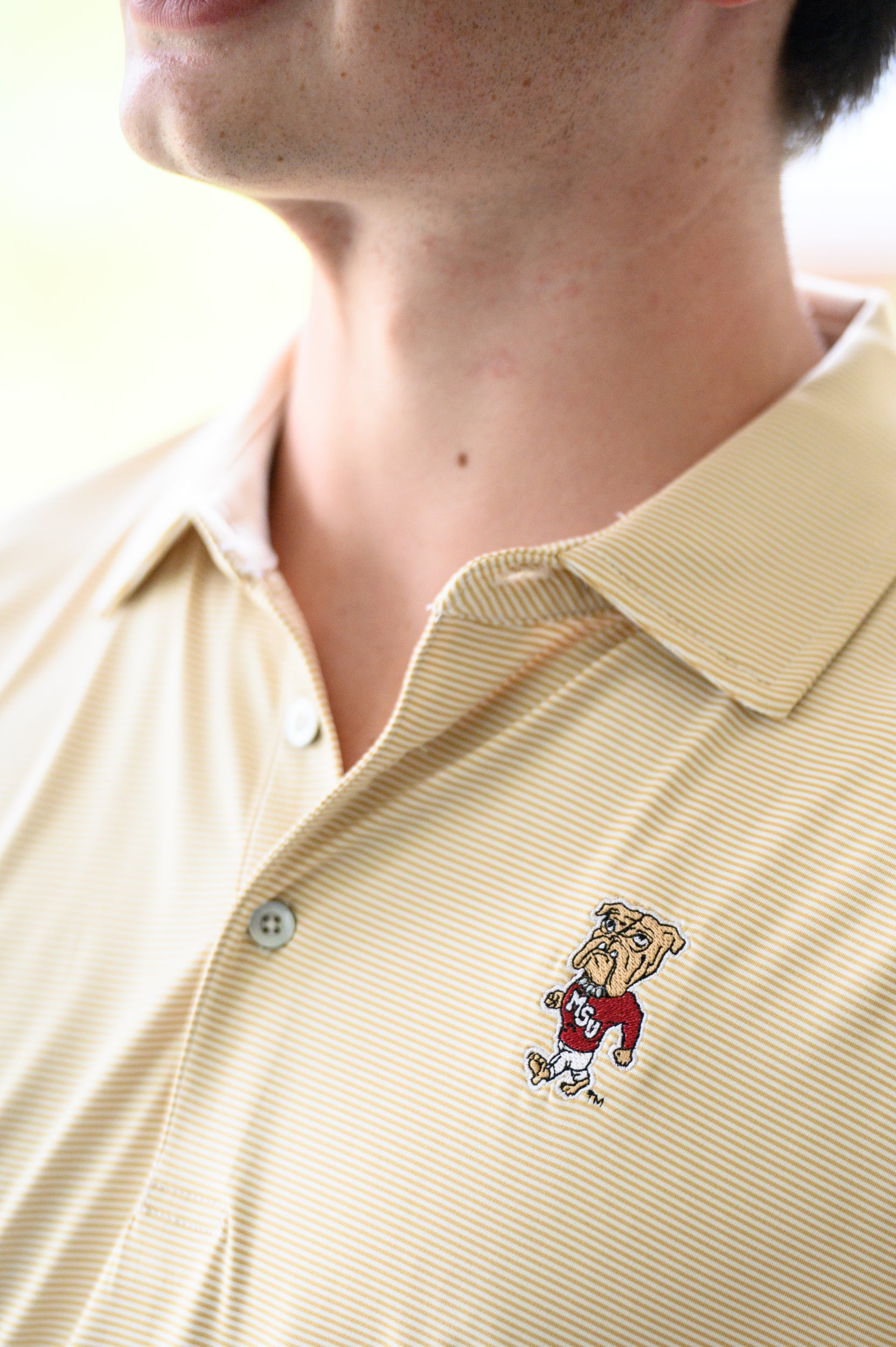 Mississippi State Tan Men’s Stripe Polo with the Walking Bully Logo embroidery