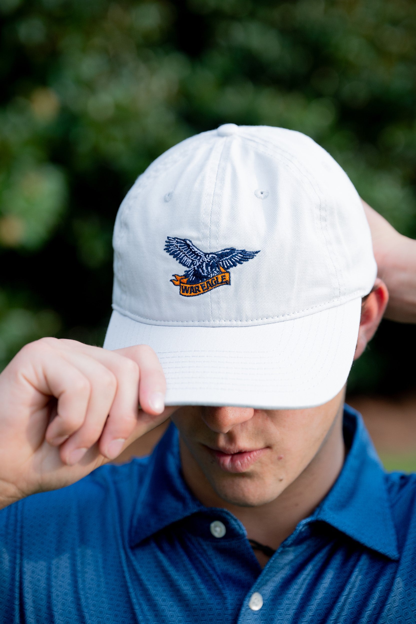 Auburn University White Dad Hat with a blue embroidered logo of the War Eagle Banner.