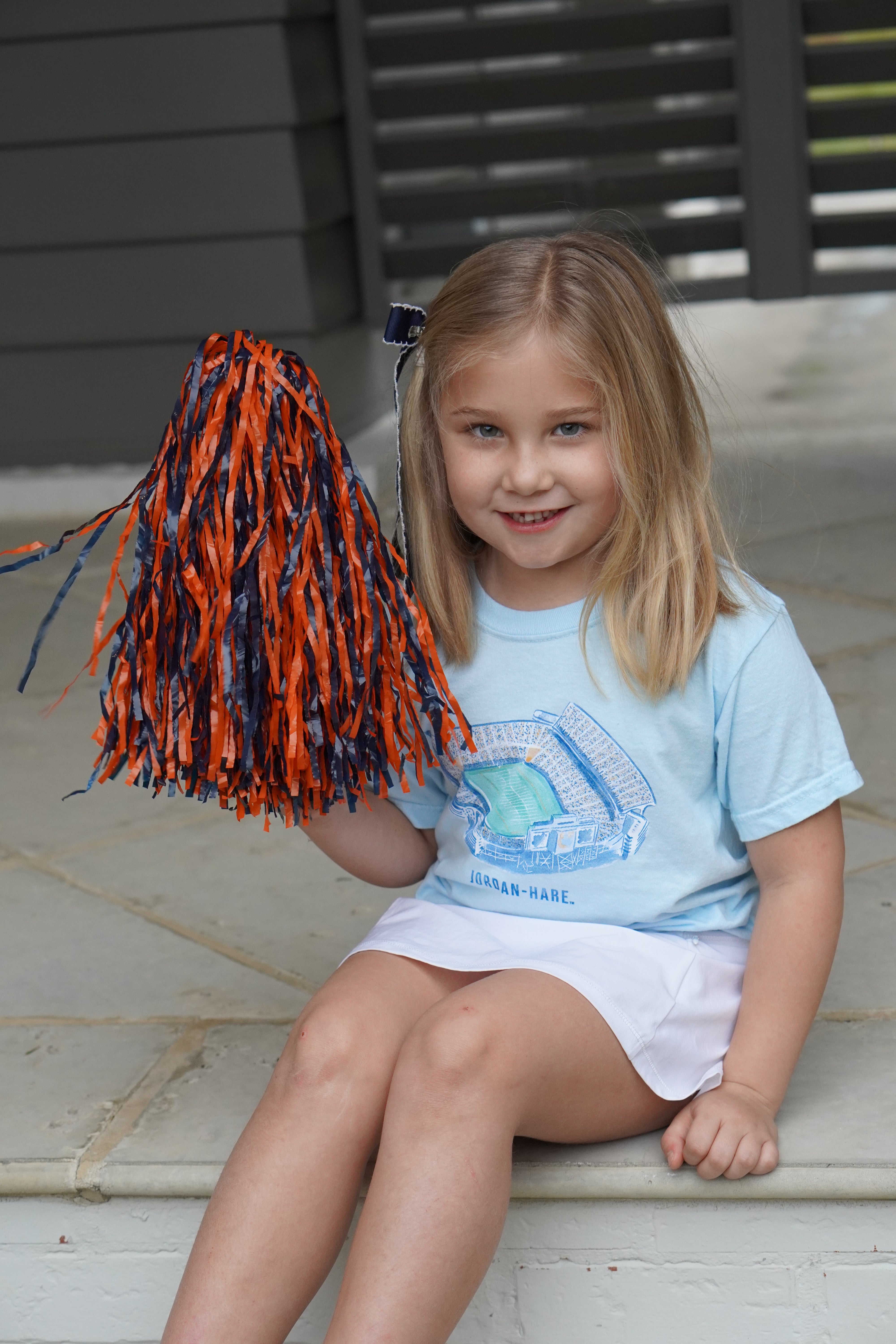 Auburn University Light Blue Youth T-Shirts with a watercolor illustration of Jordan-Hare Stadium