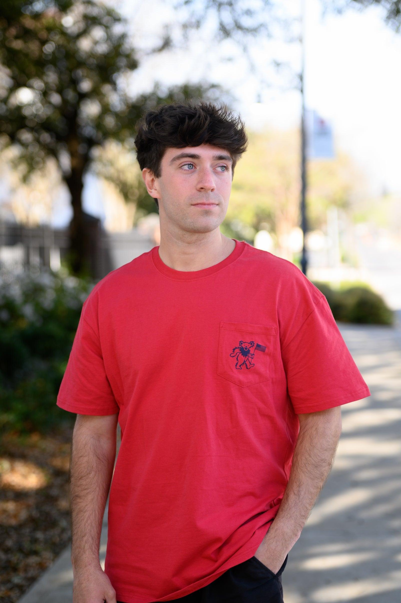 Grateful State Red T-Shirt with a front pocket design featuring a dancing bear holding a flag