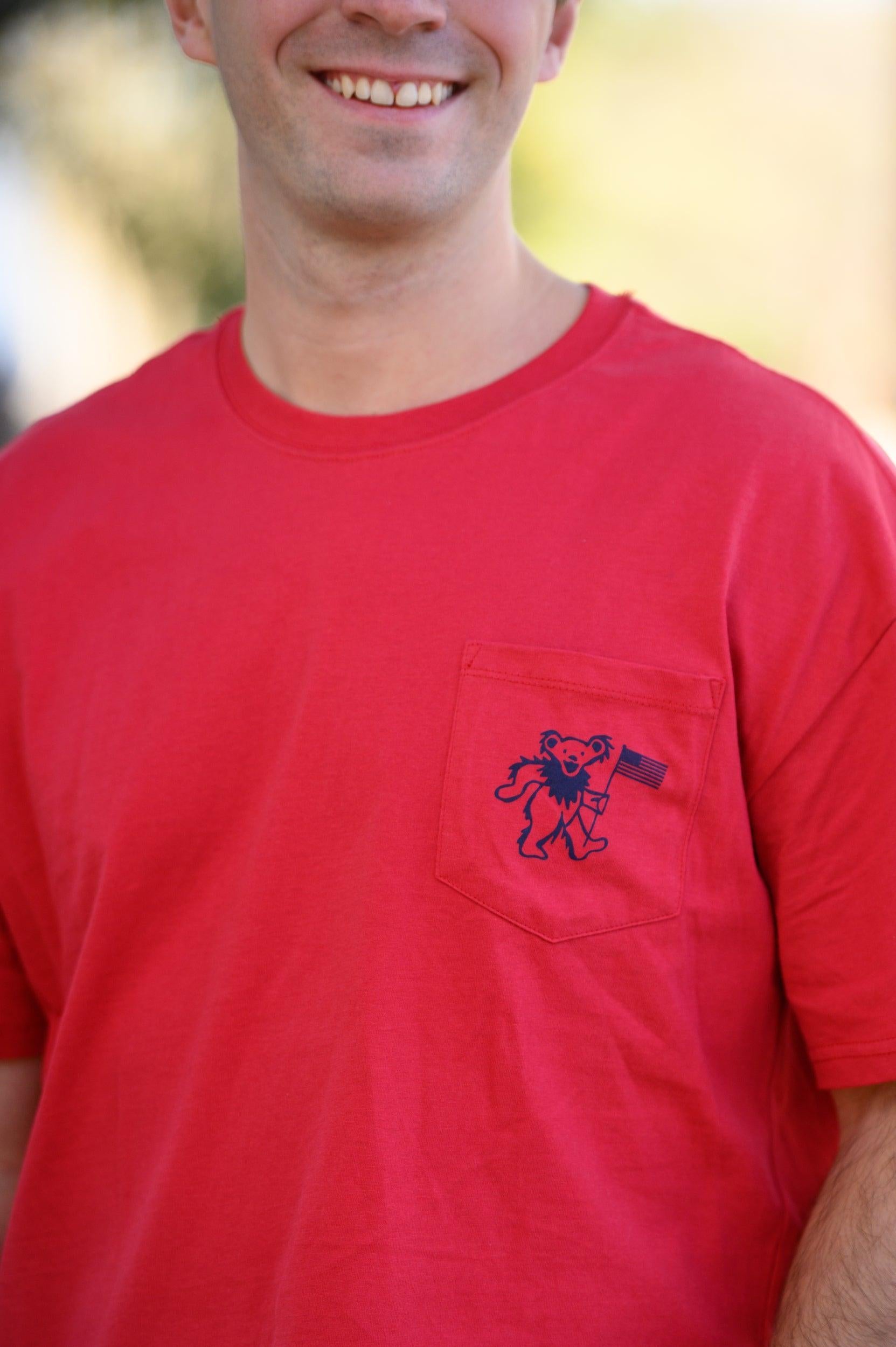 Grateful State Red T-Shirt with a front pocket design featuring a dancing bear holding a flag