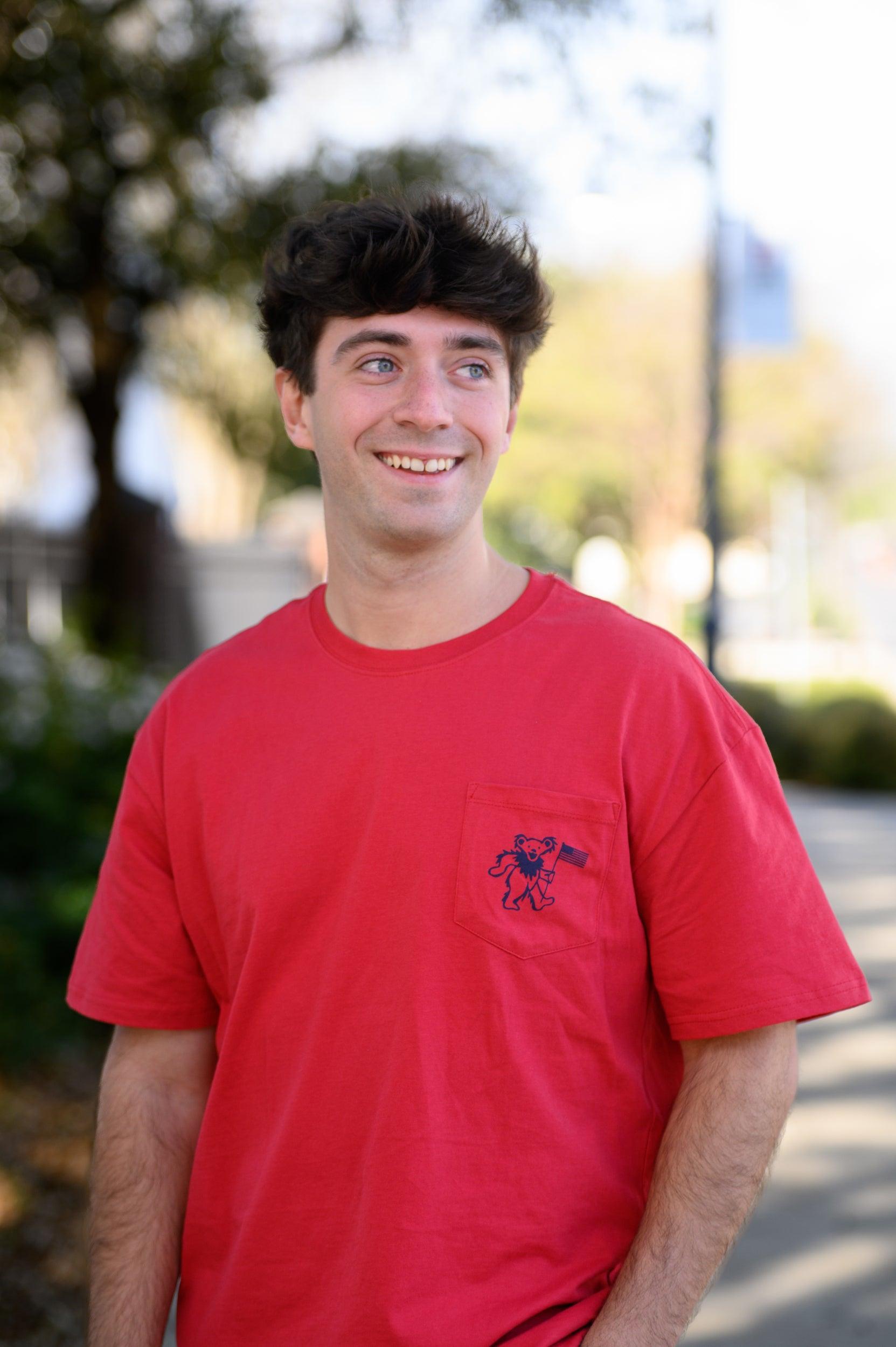 Grateful State Red T-Shirt with a front pocket design featuring a dancing bear holding a flag