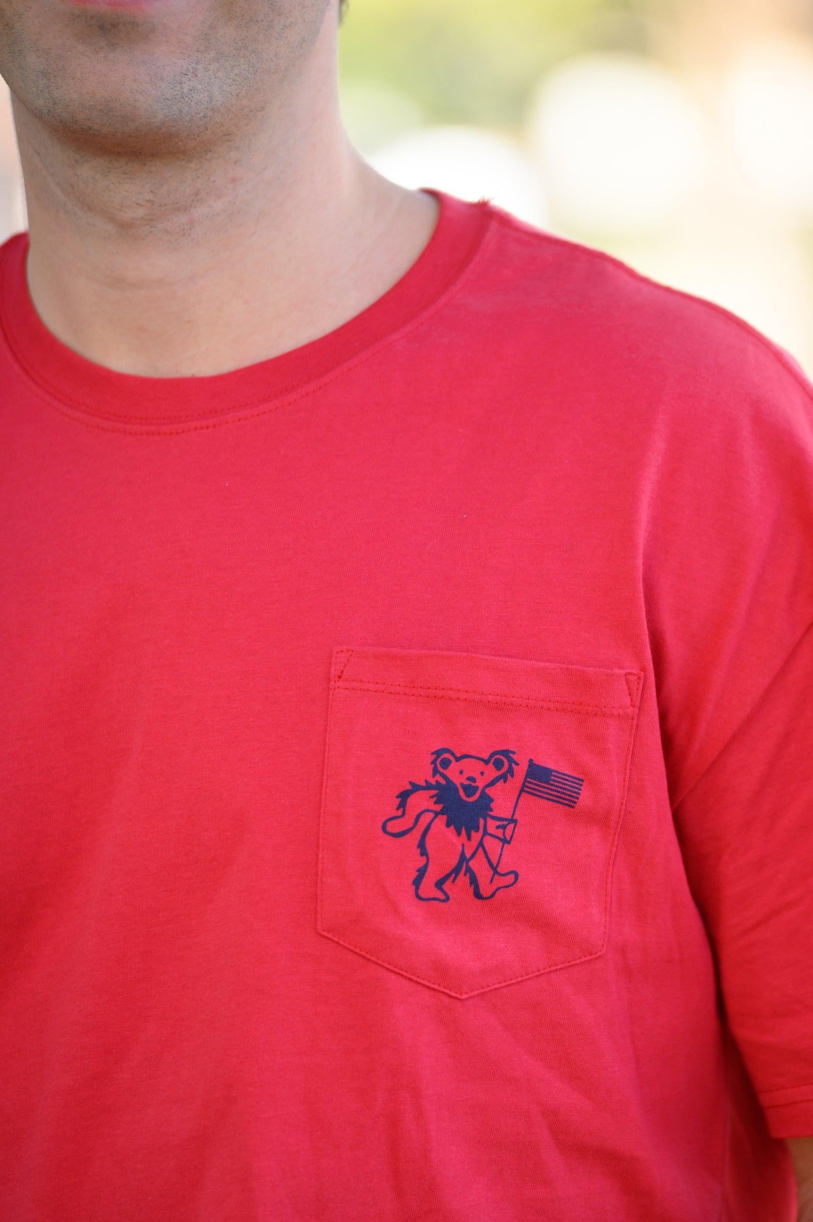 Grateful State Red T-Shirt with a front pocket design featuring a dancing bear holding a flag
