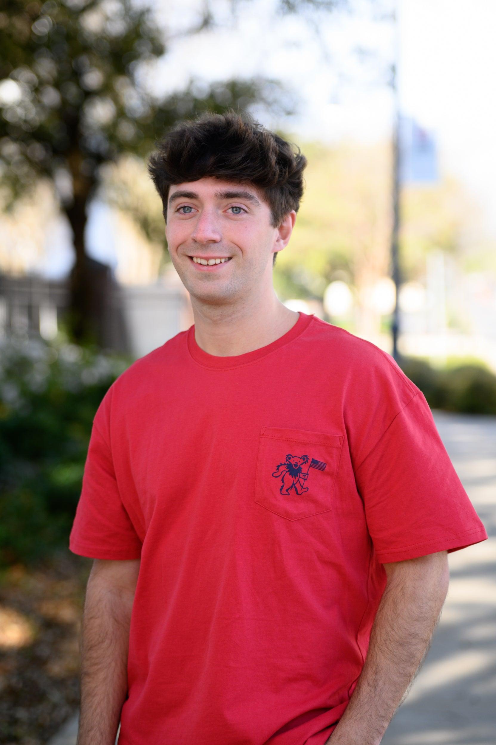 Grateful State Red T-Shirt with a front pocket design featuring a dancing bear holding a flag