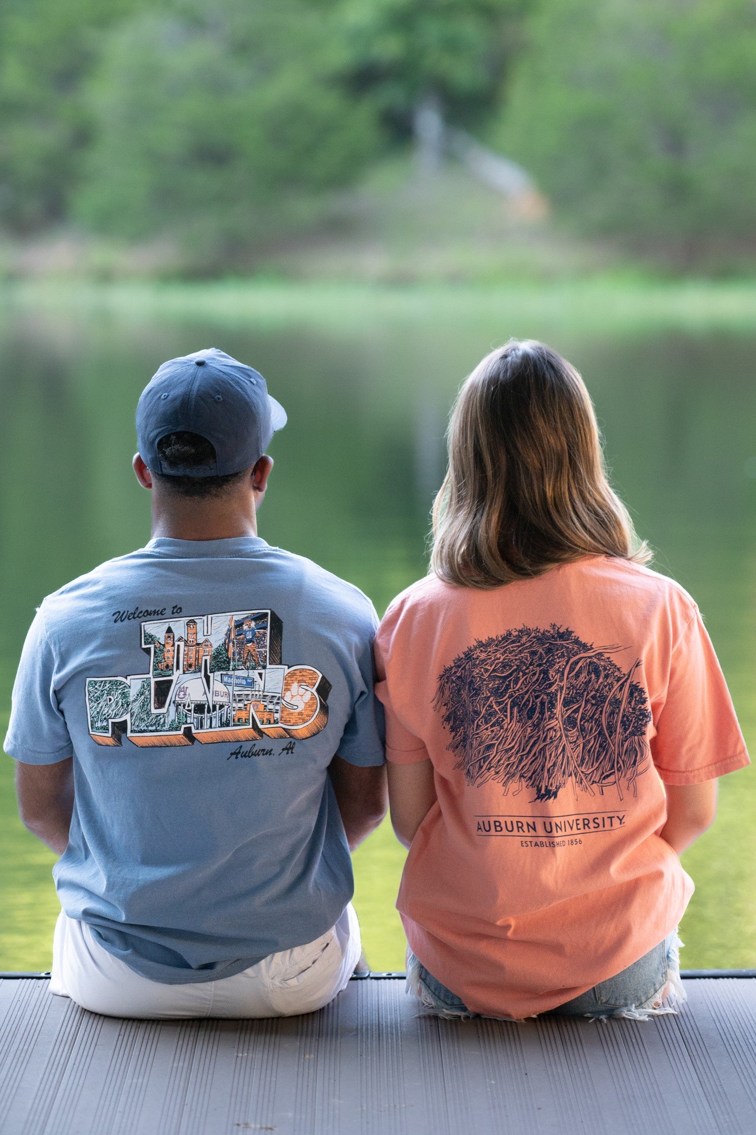 Auburn University Blue The Plains T-Shirt with postcard style text "Welcome to THE PLAINS" with "The Plains" filled with images of iconic buildings in that location