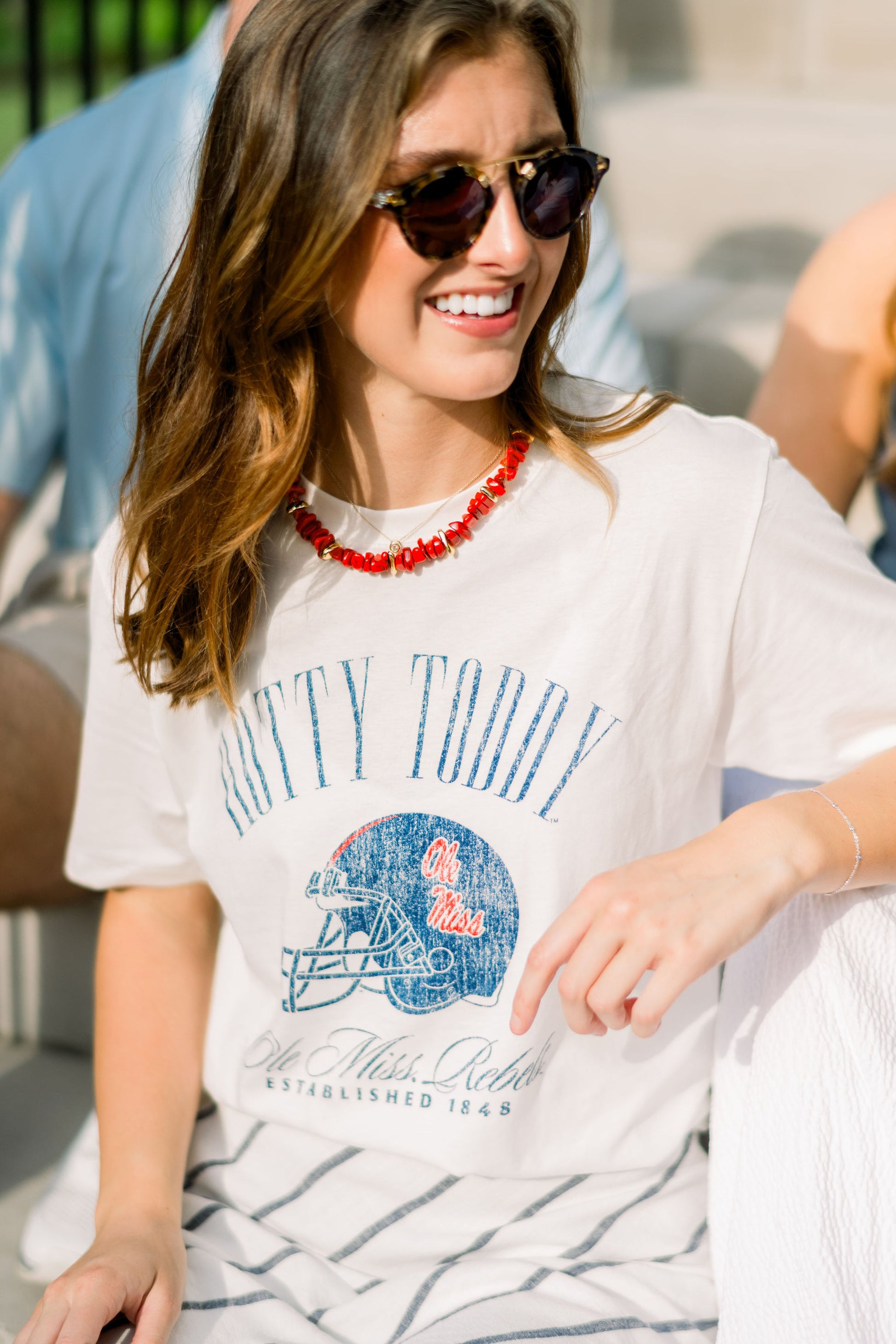 Ole Miss Ivory T-Shirt with Blue text “Hotty Toddy” above an image of a football helmet