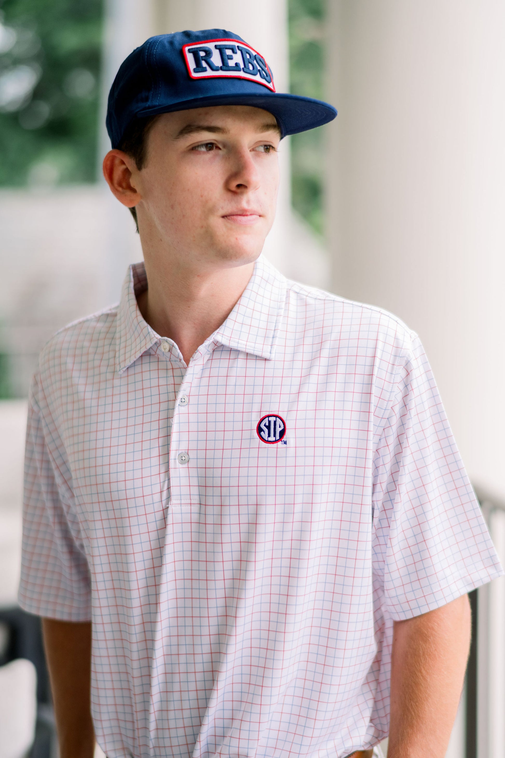Ole Miss Navy Snapback Hat featuring a White patch with Navy “REBS” embroidery