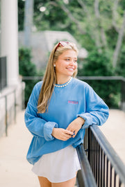 Ole Miss Blue Crewneck with the “Rebels” logo embroidered in Red on the left chest