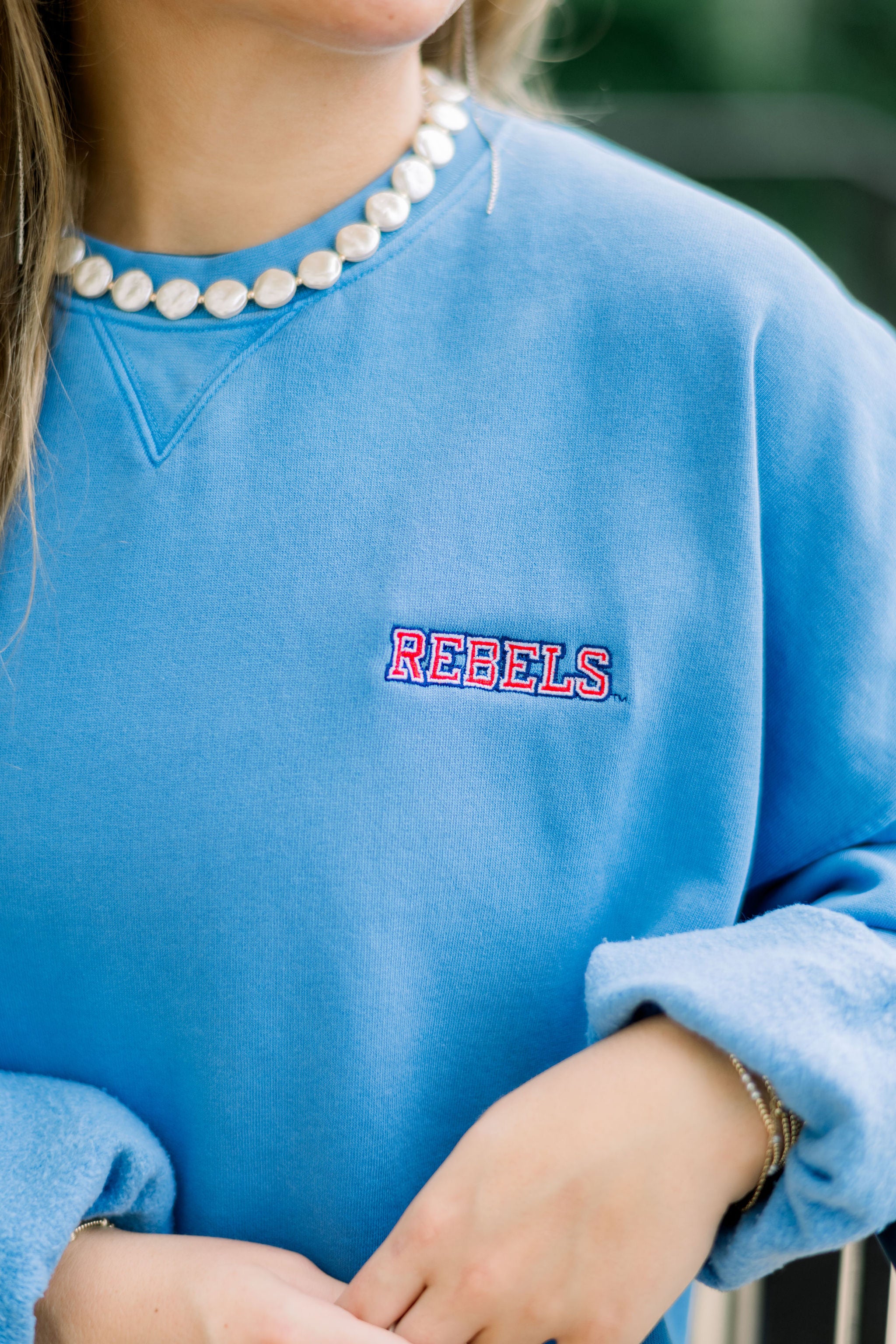 Ole Miss Blue Crewneck with the “Rebels” logo embroidered in Red on the left chest