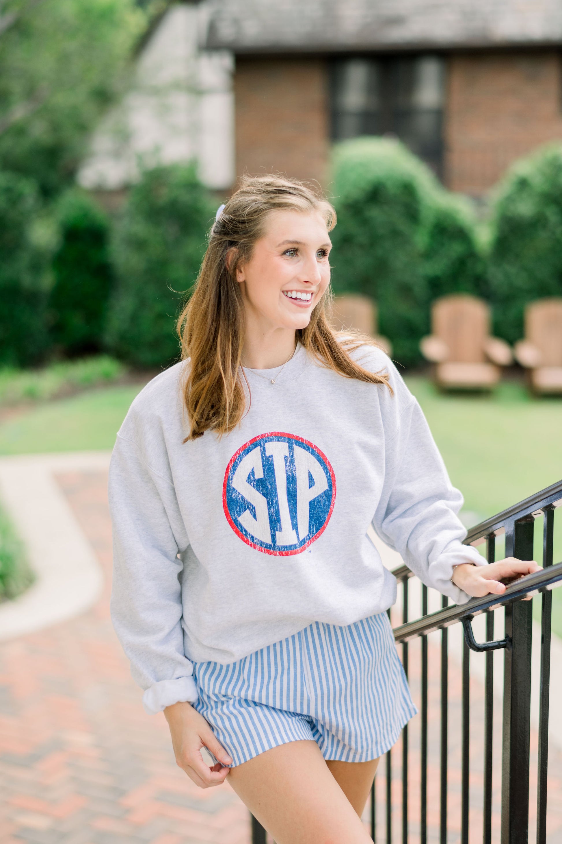 Ole Miss Light Grey Sweatshirt with a Distressed Red outlined Navy circle with White Text “SIP” inside