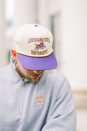 LSU Tan Hat with a Purple brim featuring text “Louisiana State University” surrounding a leaping Bengal tiger 