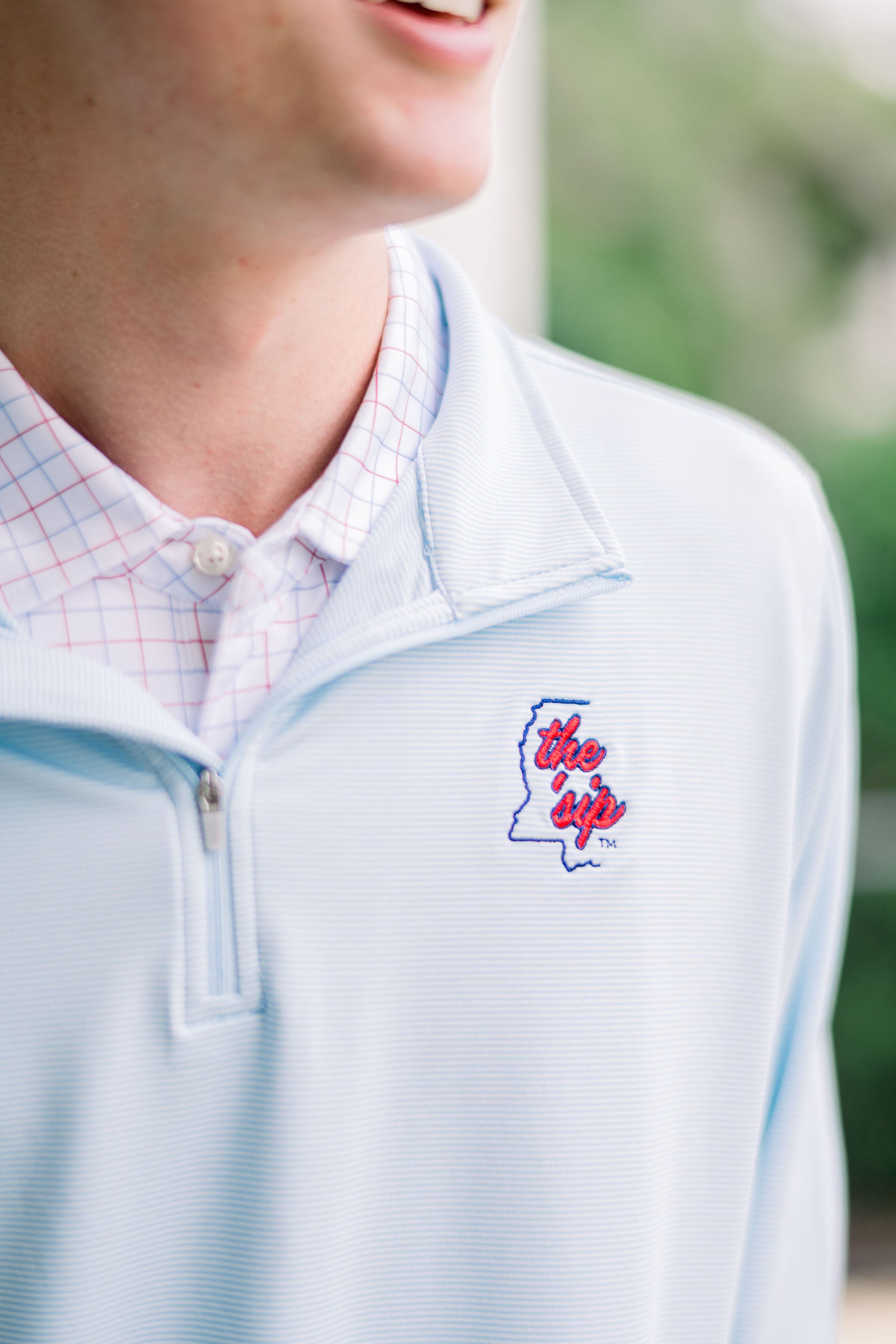 Ole Miss Light Blue ¼ Zip Pullover with text “The ‘Sip” inside of an outline of Mississippi embroidered on the left chest