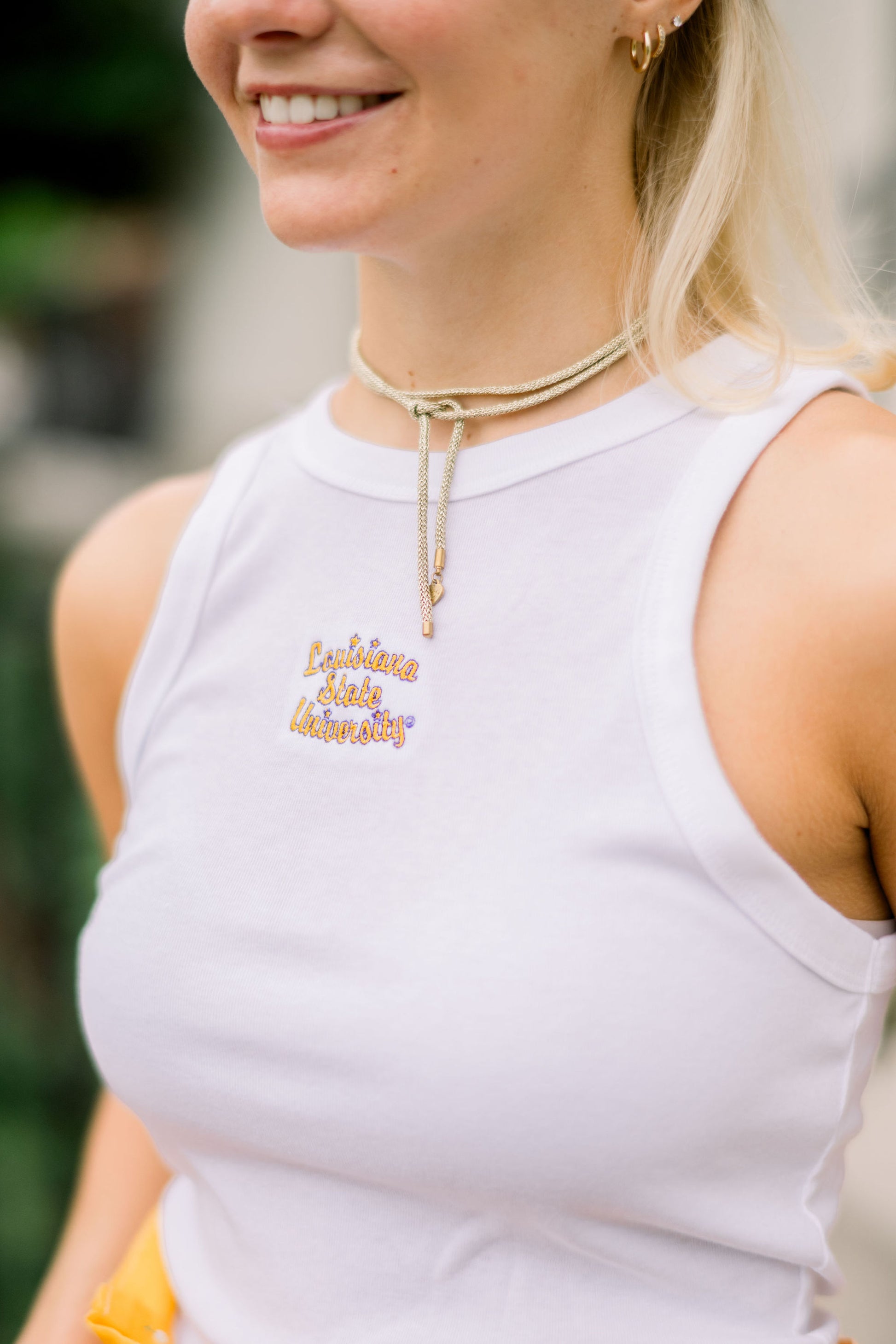 LSU White Ribbed Tank Top with Yellow and Purple Script “Louisiana State University” embroidered on the chest