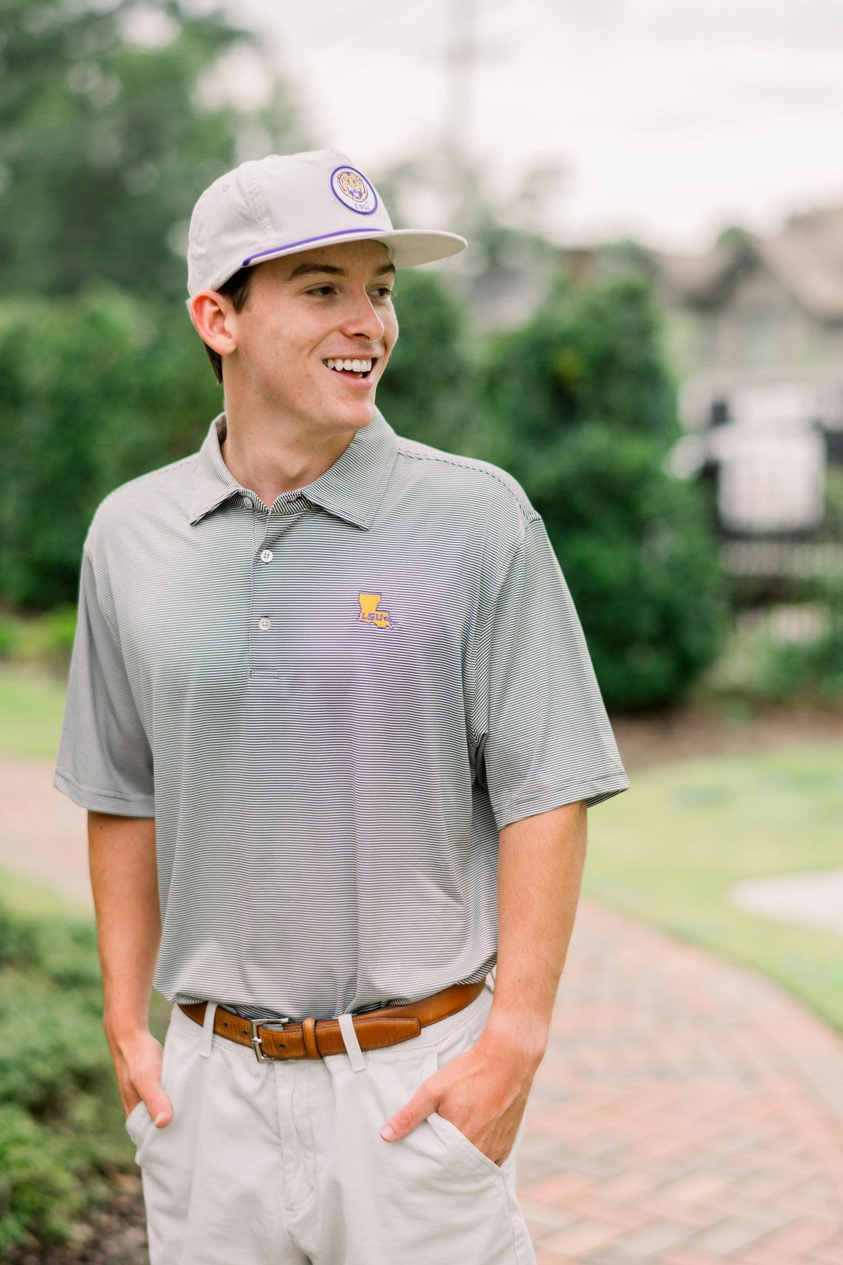LSU Men’s Grey Stripe Polo with the Louisiana state outline embroidered on the chest