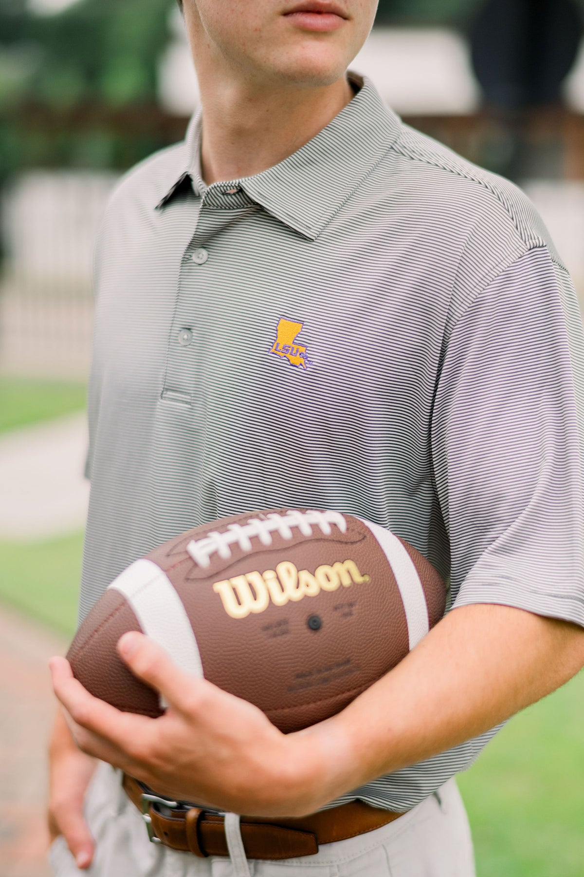 LSU Men’s Grey Stripe Polo with the Louisiana state outline embroidered on the chest