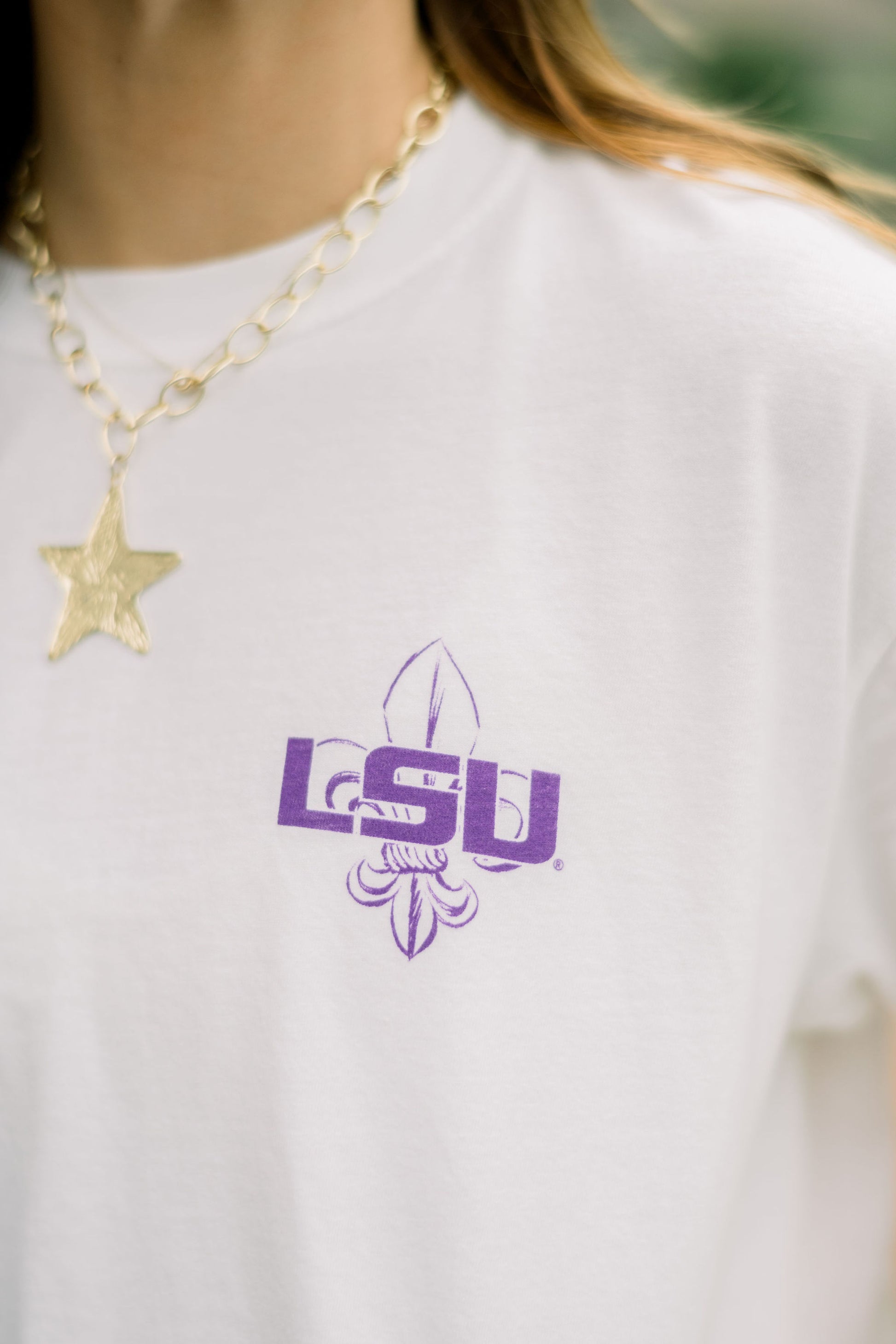 Louisiana State University White T-Shirt with postcard style text “Baton Rouge” with images of a tiger, Tiger Stadium, the Memorial Tower, and the New Bridge