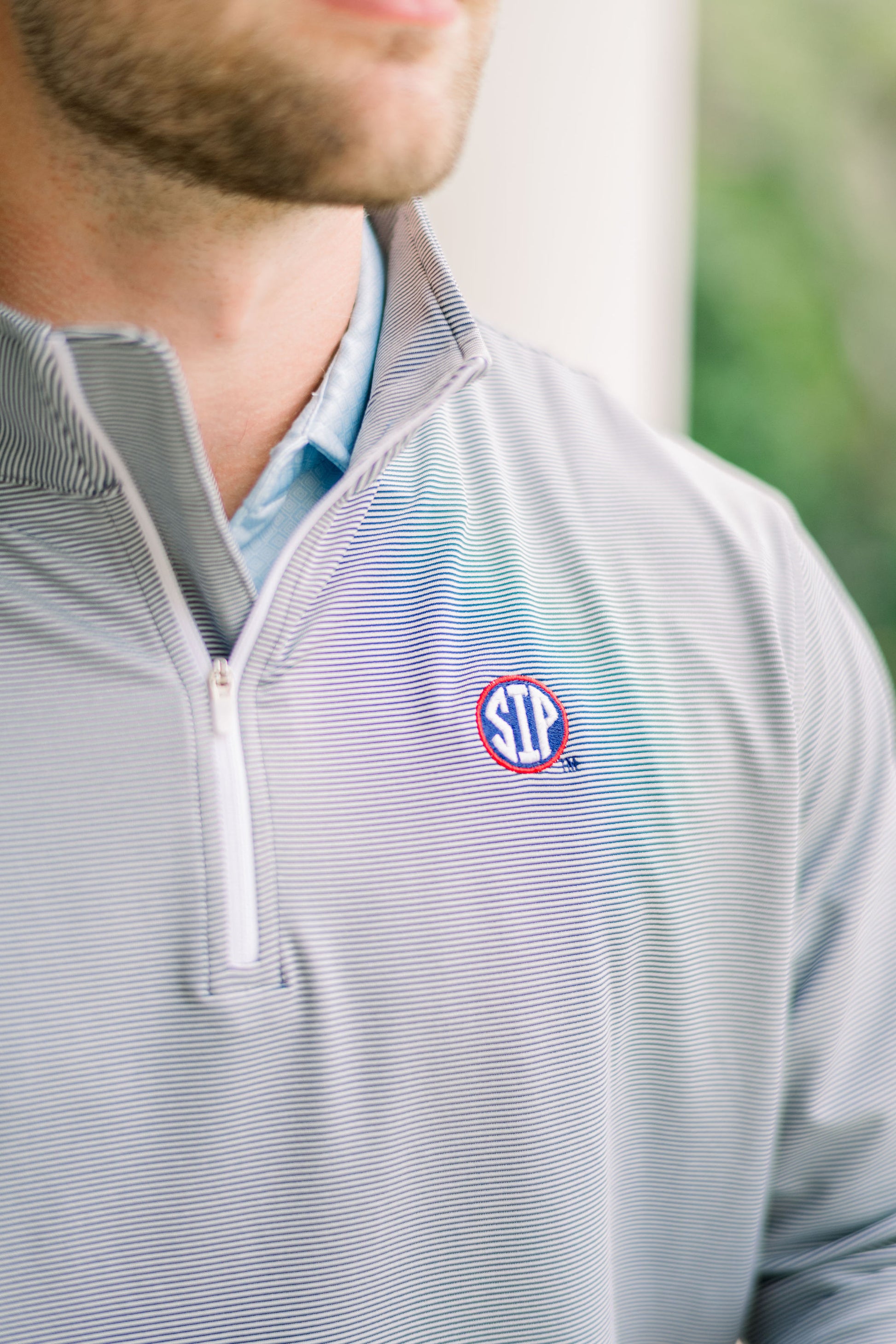Ole Miss Navy Stripe ¼ Zip Pullover with the SIP Circle Logo embroidered on the left chest