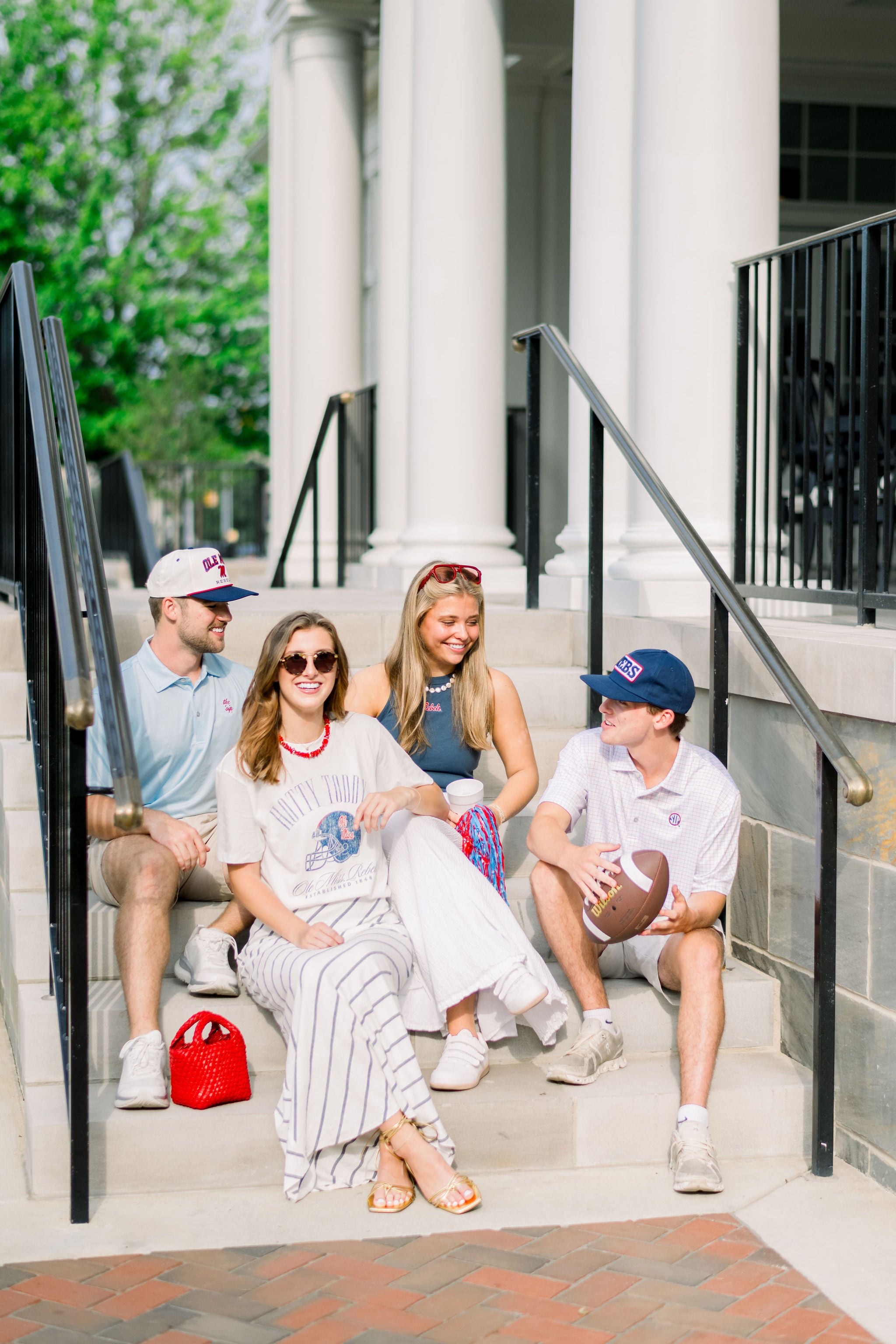 Ole Miss Ivory T-Shirt with Blue text “Hotty Toddy” above an image of a football helmet