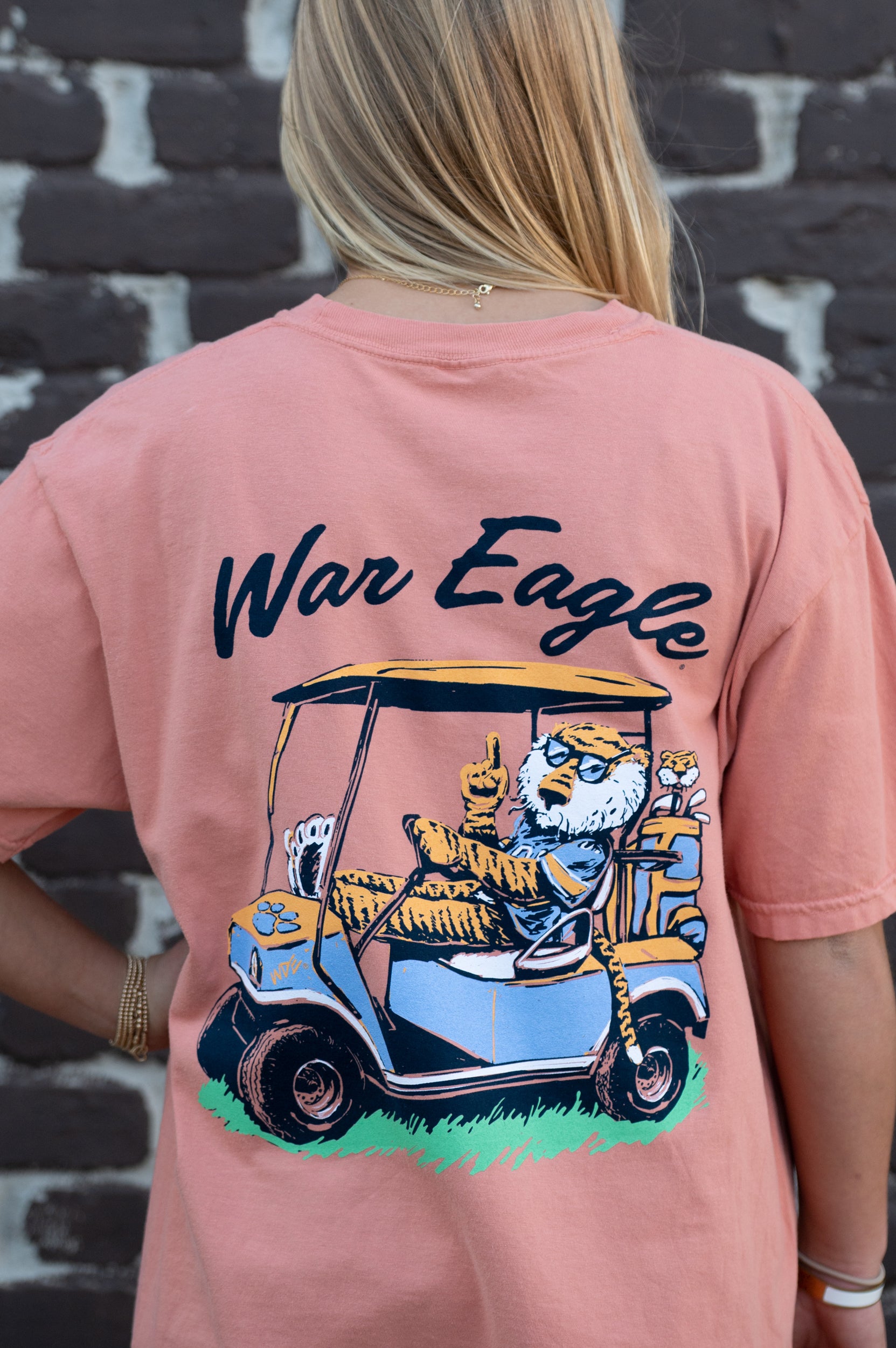 Auburn University Aubie Golf Cart Terracotta Comfort Colors T-Shirt  with the text "War Eagle" above an image of Aubie the Tiger wearing sunglasses and driving a golf cart