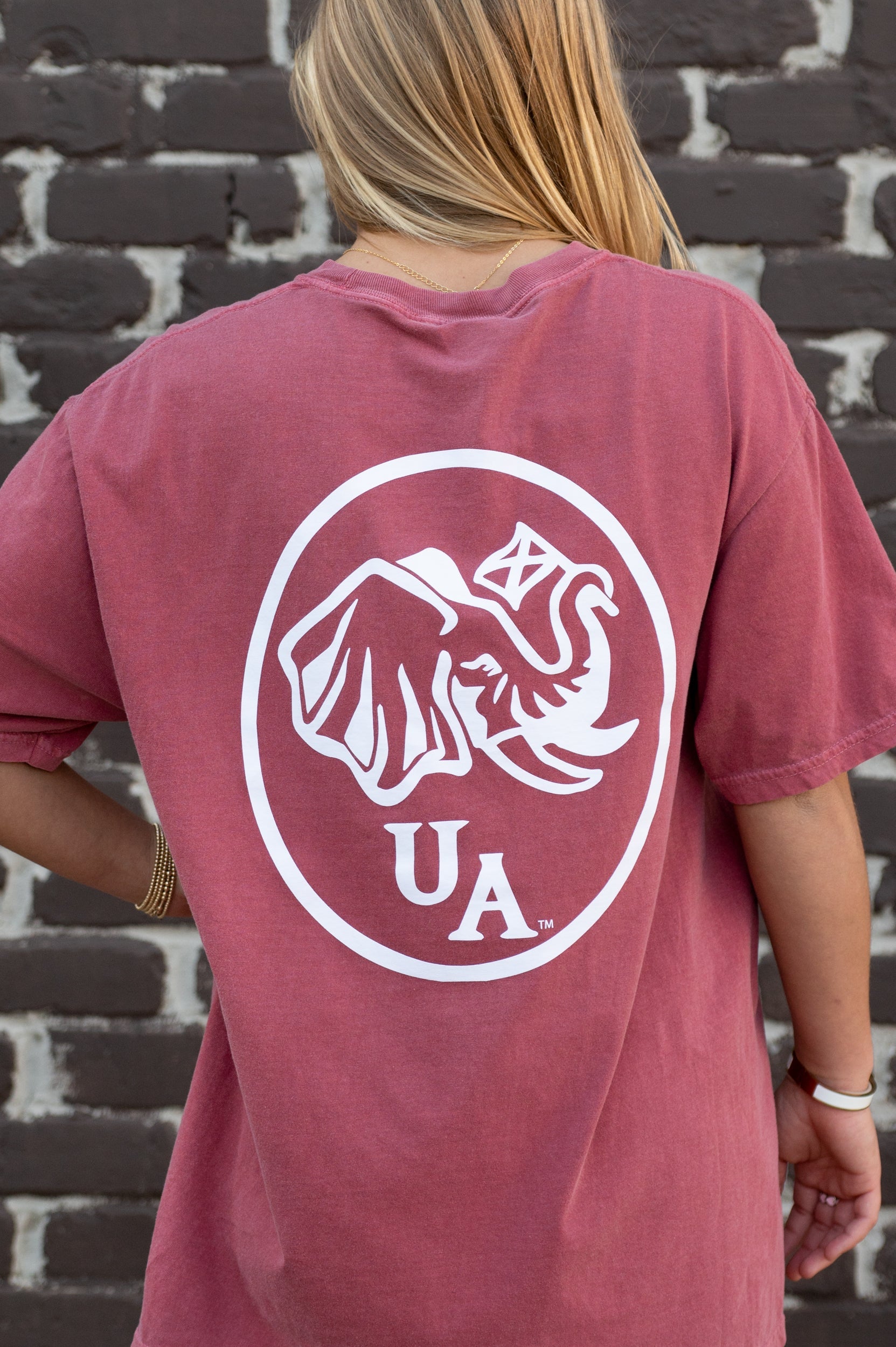University of Alabama Red Elephant Seal T-Shirt with an image of an elephant holding an Alabama State flag above he letters "UA"